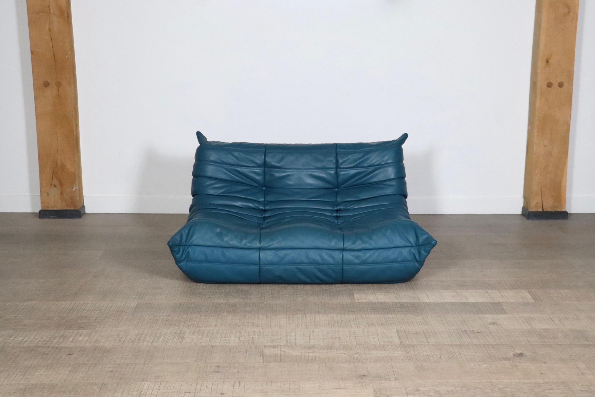 Beautiful Ligne Roset Togo two seater sofa in original Petrol blue leather by Michel Ducaroy, 1970s. This iconic design has become more and more popular over the years. The lightweight design combined with fun colors and materials make these seating