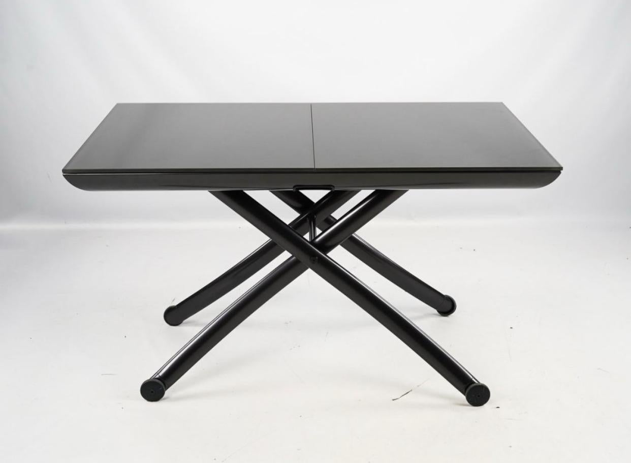 Pagnon & Pelhaître for Ligne Roset YoYo Table that adjusts in height from 15.25 inches  to 31.5 inches. And also adjust in width from 49.25 inches to 64.25 inches. Making this an extremely versatile table that can be used as a coffee table as well