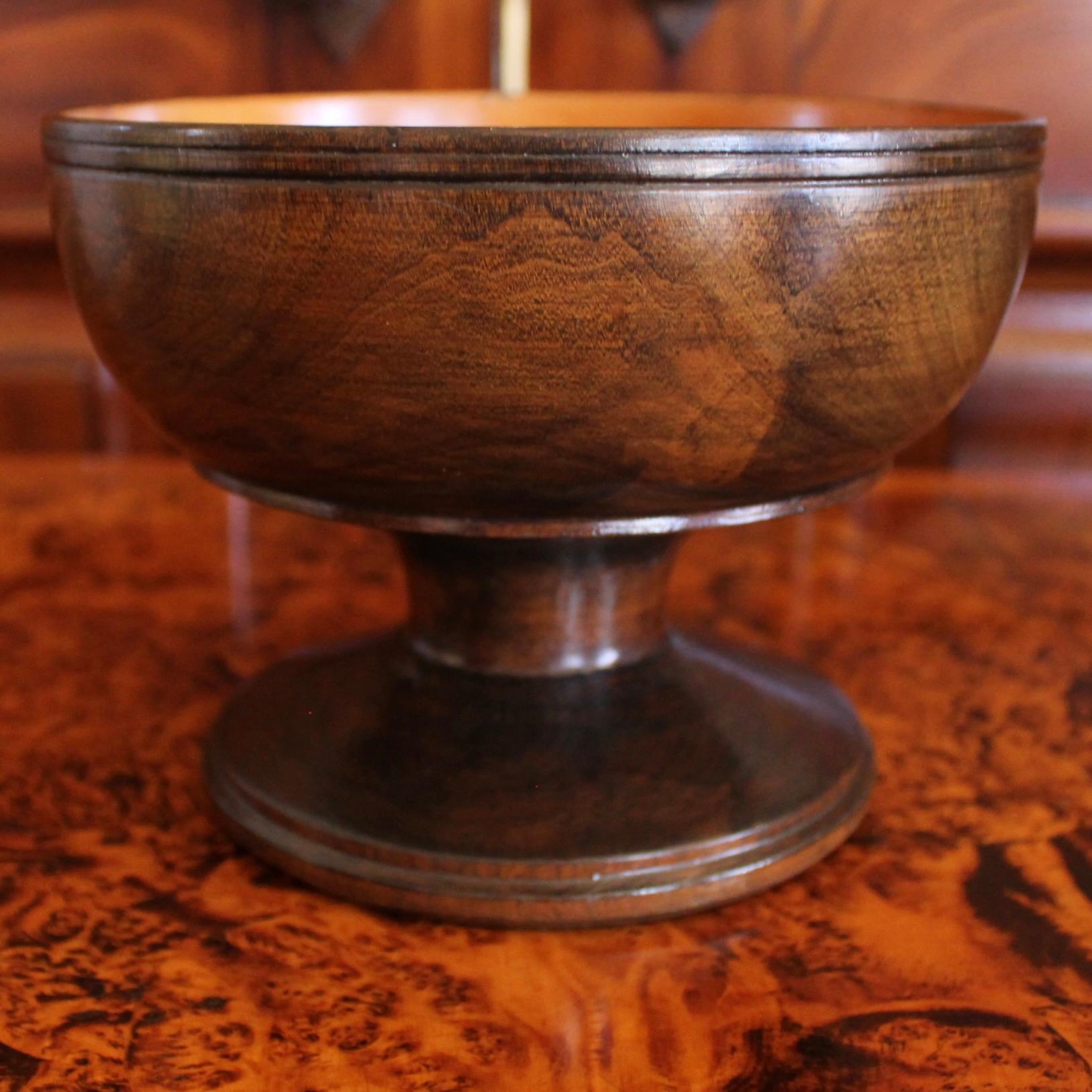 A handsome turned wooden vessel, hewn from a single piece of lignum vitae, presented in a classic two tone sapwood/heartwood contrasting design: richly veined dark heartwood on the outside with deep caramel tones on the interior. Lignum vitae is a