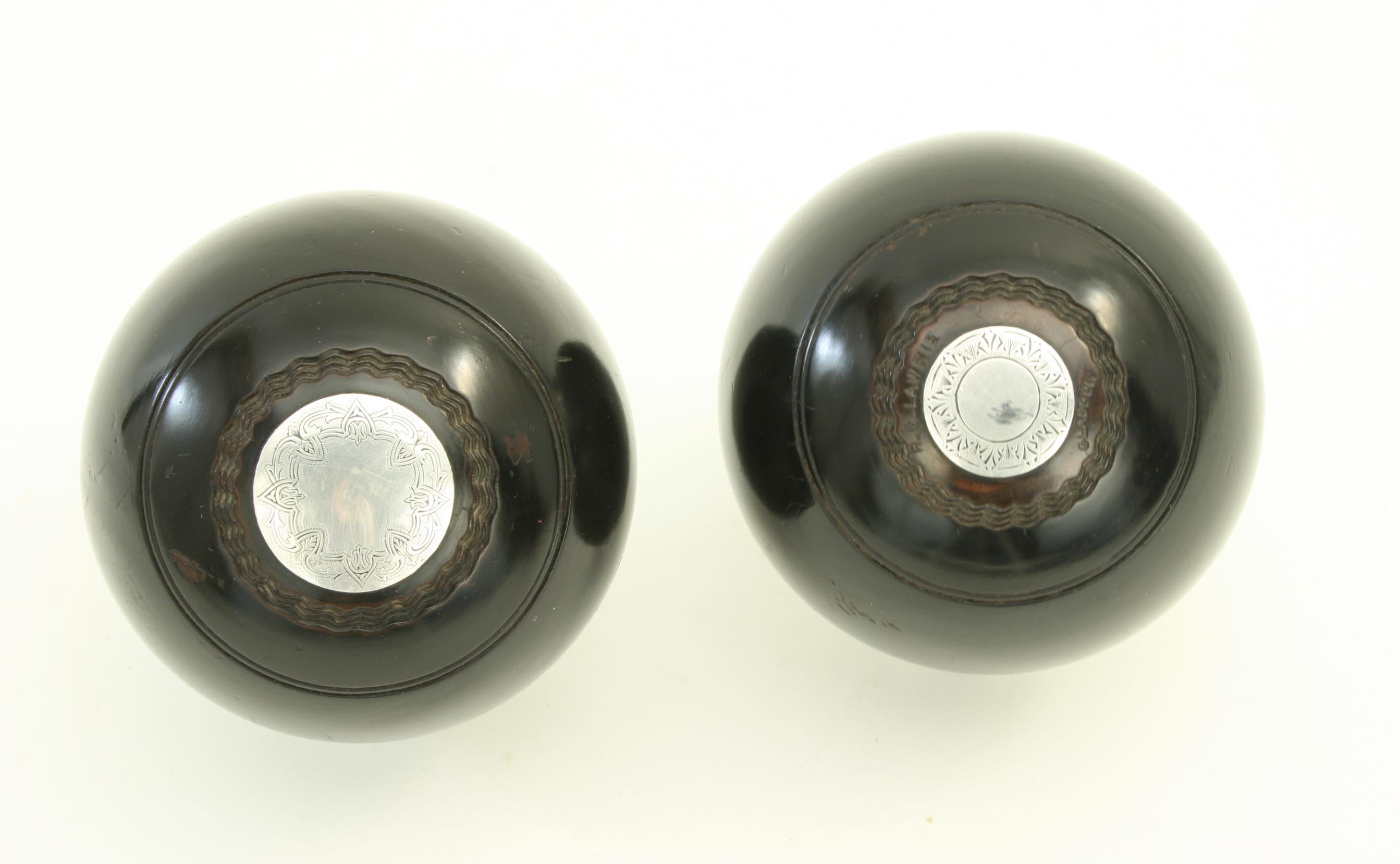 Lignum Vitae presentation lawn bowls.
A very nice pair of miniature Victorian ebonized lignum vitae presentation lawn bowls with silvered plaques. The front discs are larger than the rear ones but all are engraved with a pattern around the outer