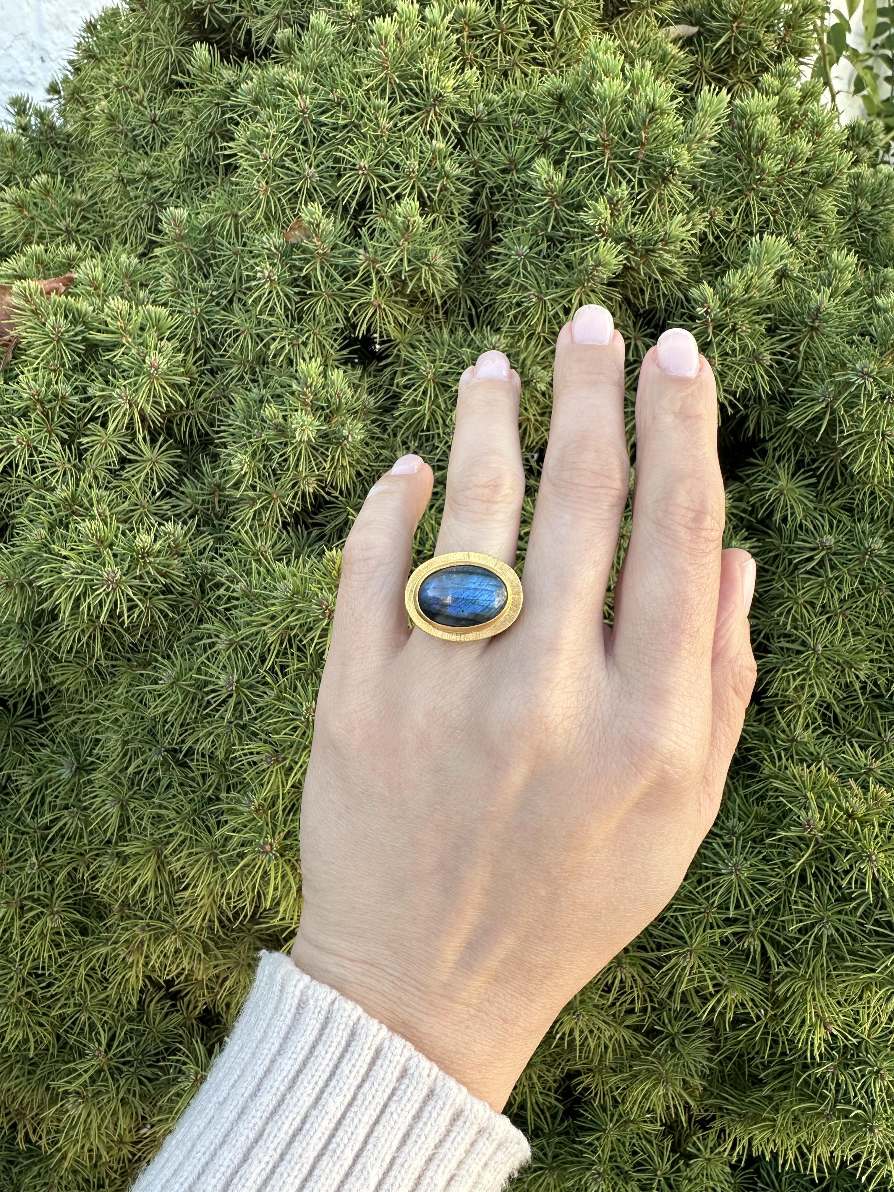 –Stone(s)–
(1) Natural Genuine  Labradorite - Oval Cabochon Cut - Bezel Set - Blue Color - 16.4x11.6mm (approx.)

Material: Blackened Sterling Silver .925 - High Karat Yellow gold
Weight: 12.39 Grams
Ring Size: 6.0 ( fitted on finger, we can NOT