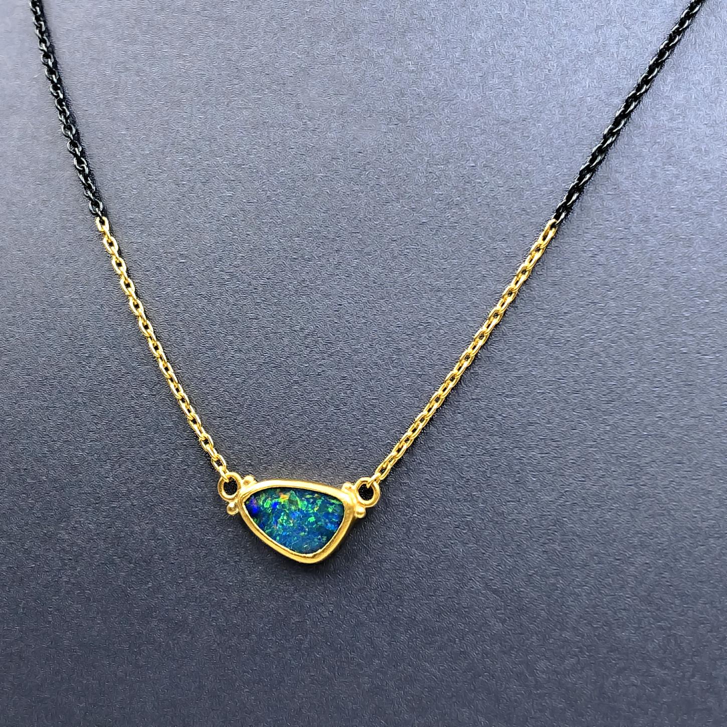 Opal Doublet Drop Necklace handcrafted by acclaimed jewelry maker Lika Behar featuring a stunning Australian blue opal doublet with rainbow fire, bezel-set in 24k gold and attached to a 24k gold and oxidized sterling silver chain. 18 inches with