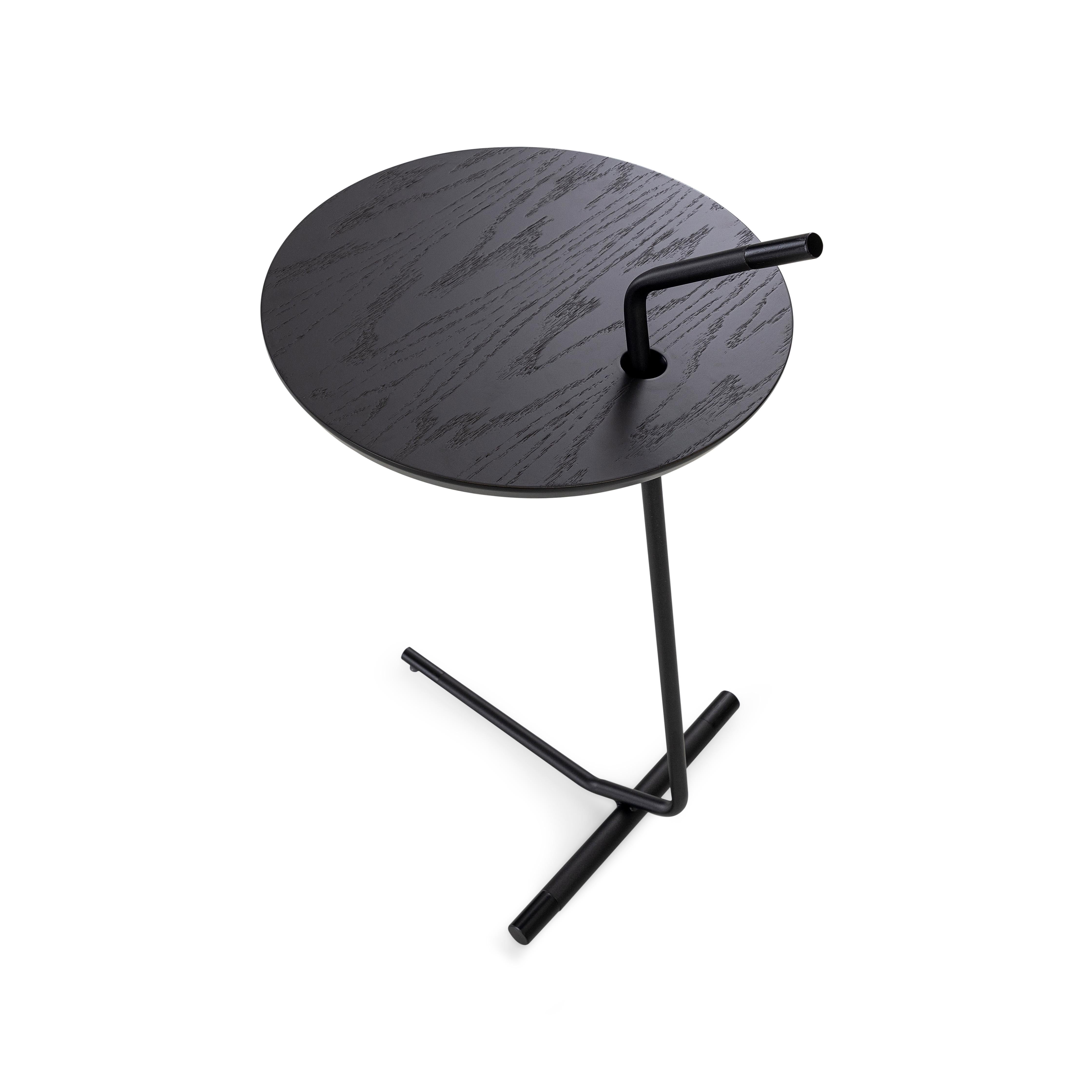 The like side table features a wood top in black oak finish and a metal base. This table is made of parallels, giving a distinctive shape and an unconventional look. This table features a black oak wood finish and the metal will attract all the