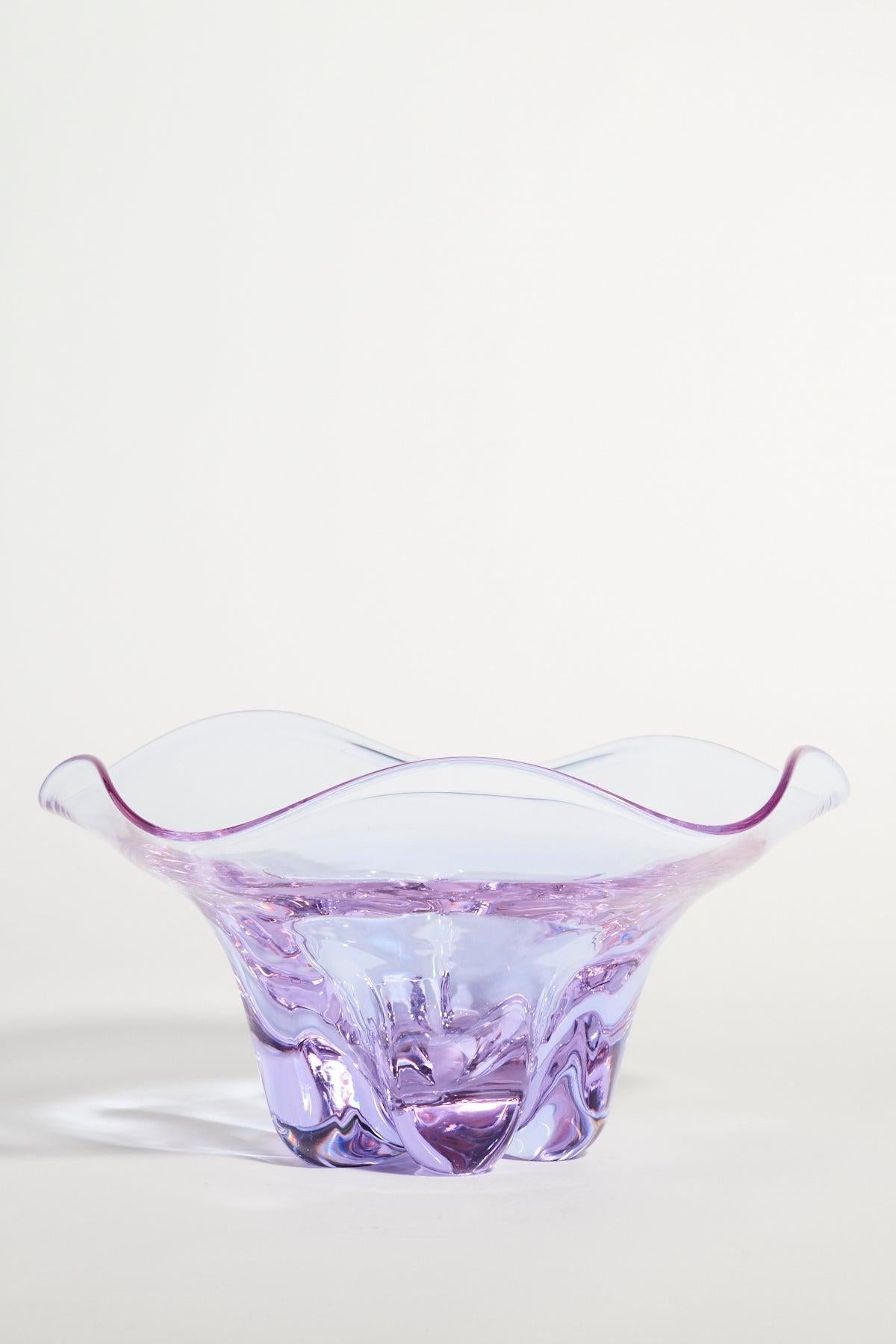 Translucent lilac glass bowl with ruffled edge and heavy base.