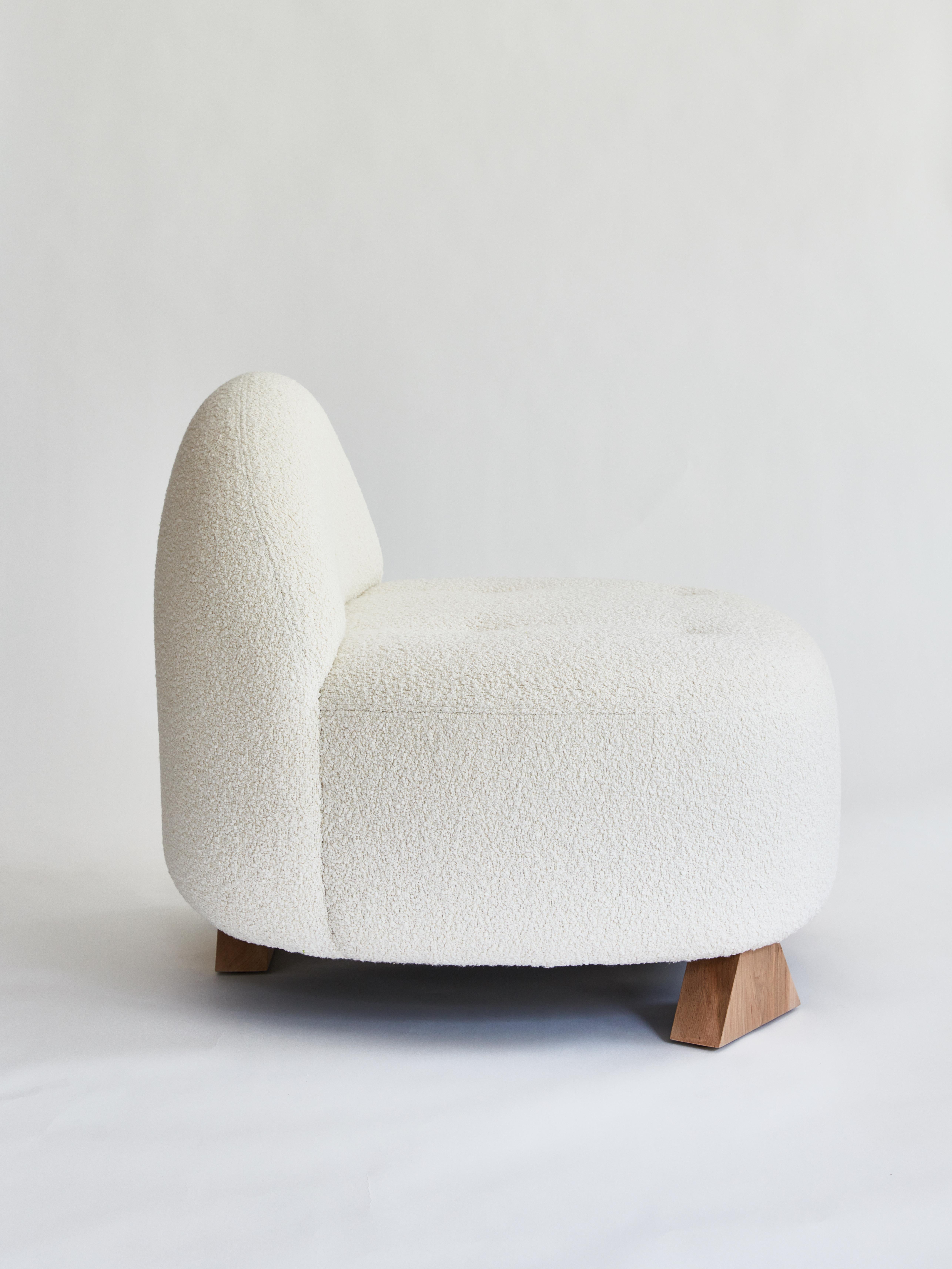 Made to order wood & bouclé club chair designed by Christian Siriano.

Legs: Stained Maple
Body: Ivory Bouclé

Measures: Seat height: 17”
Seat depth: 26” 

Overall height: 30” 
Overall depth: 31”
Overall width: 34”.
 