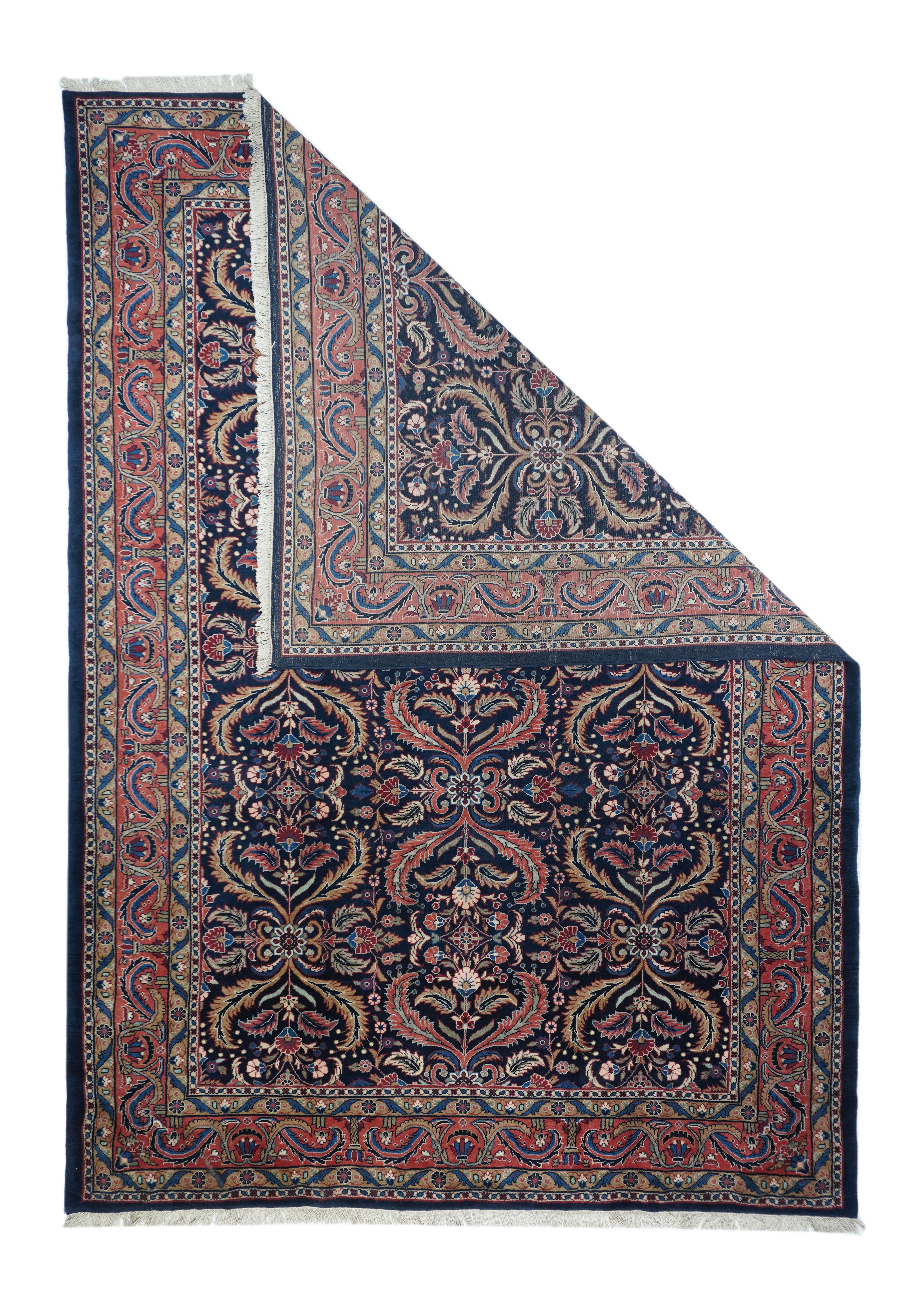 This visually striking, and probably unique designwise, SE Persian city carpet of medium-fine weave, shows a navy indigo field precisely, but not stiffly, covered by a three column allover pattern of pairs of curved, barbed leaves, with lesser