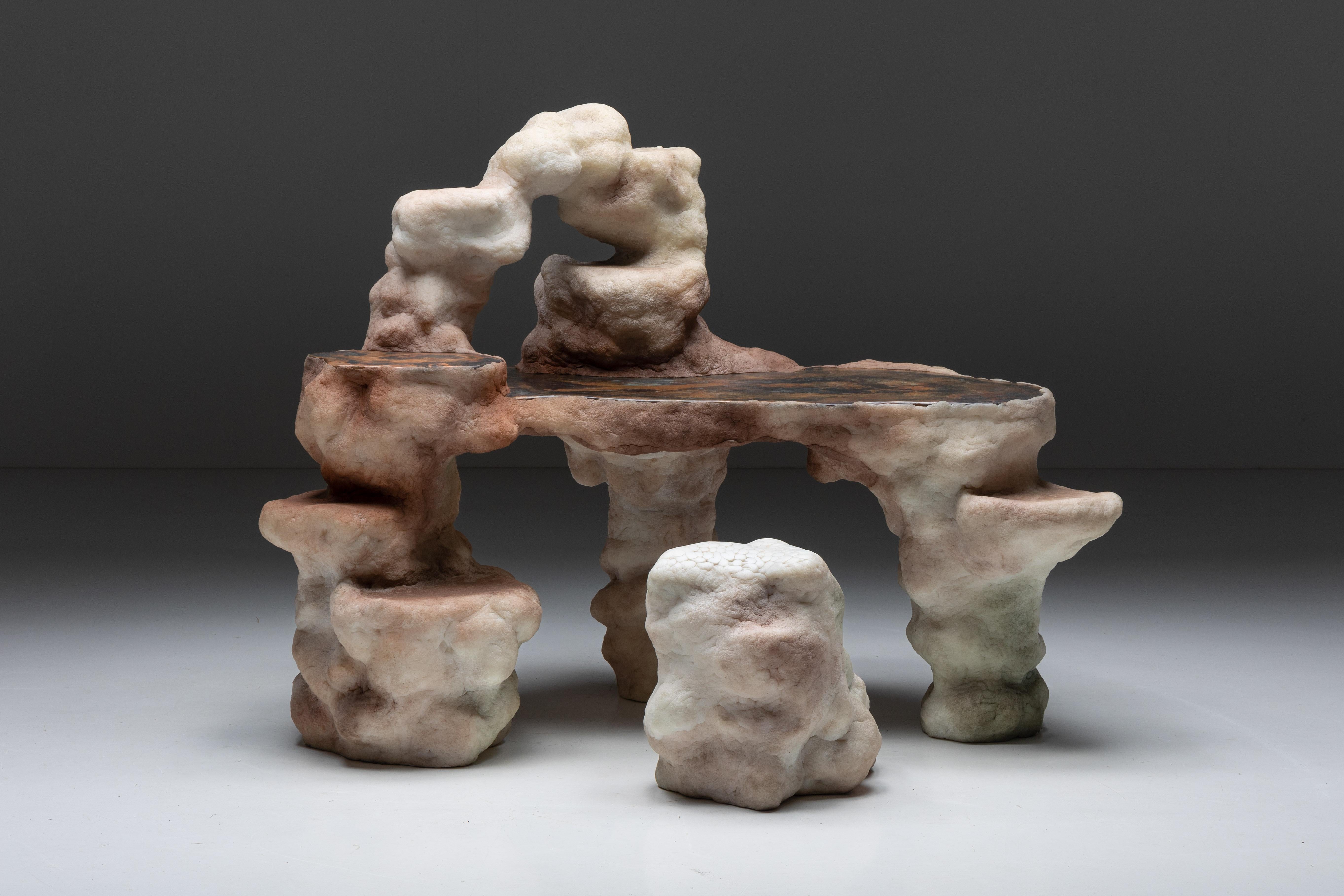 Elissa Lacoste's 'I Dream of Megalithic Times' series: lithic desk and desk chair. Composed of various speleothem-like shapes emerging from silicone skins infused with earthly pigments. This collection of functional art pieces challenges