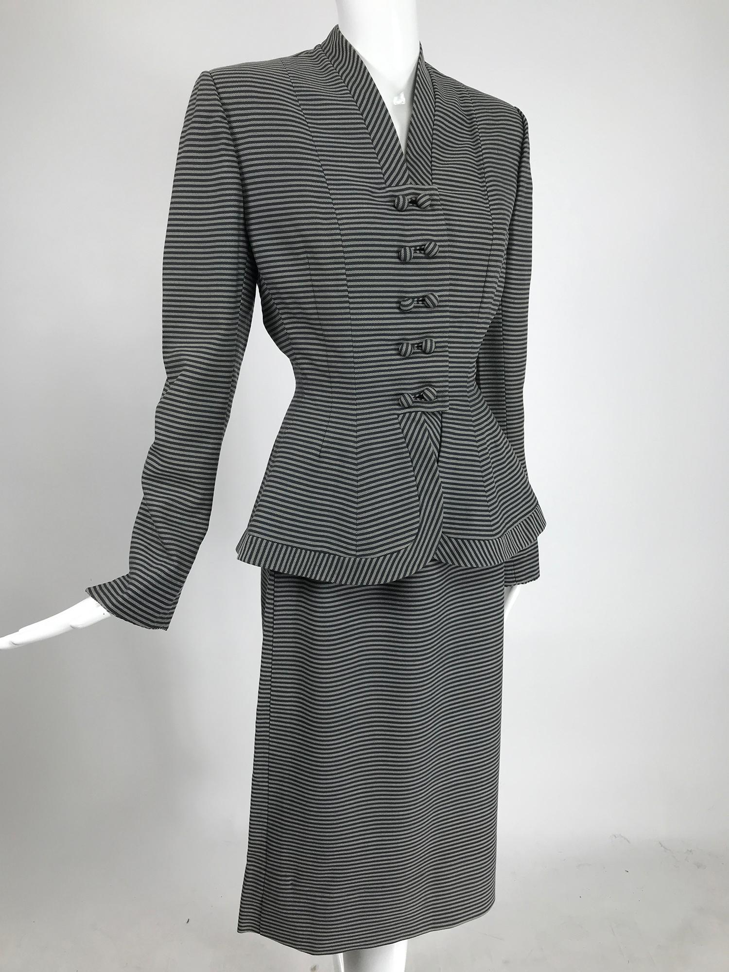 Lilli Ann 1940s nip waist peplum hem black and white stripe wool skirt suit. Stylish suit, the jacket gives a nod to Christian Dior's Bar suit. This jacket is really great in narrow black and white horizontal stripes, the neck and hem facings are
