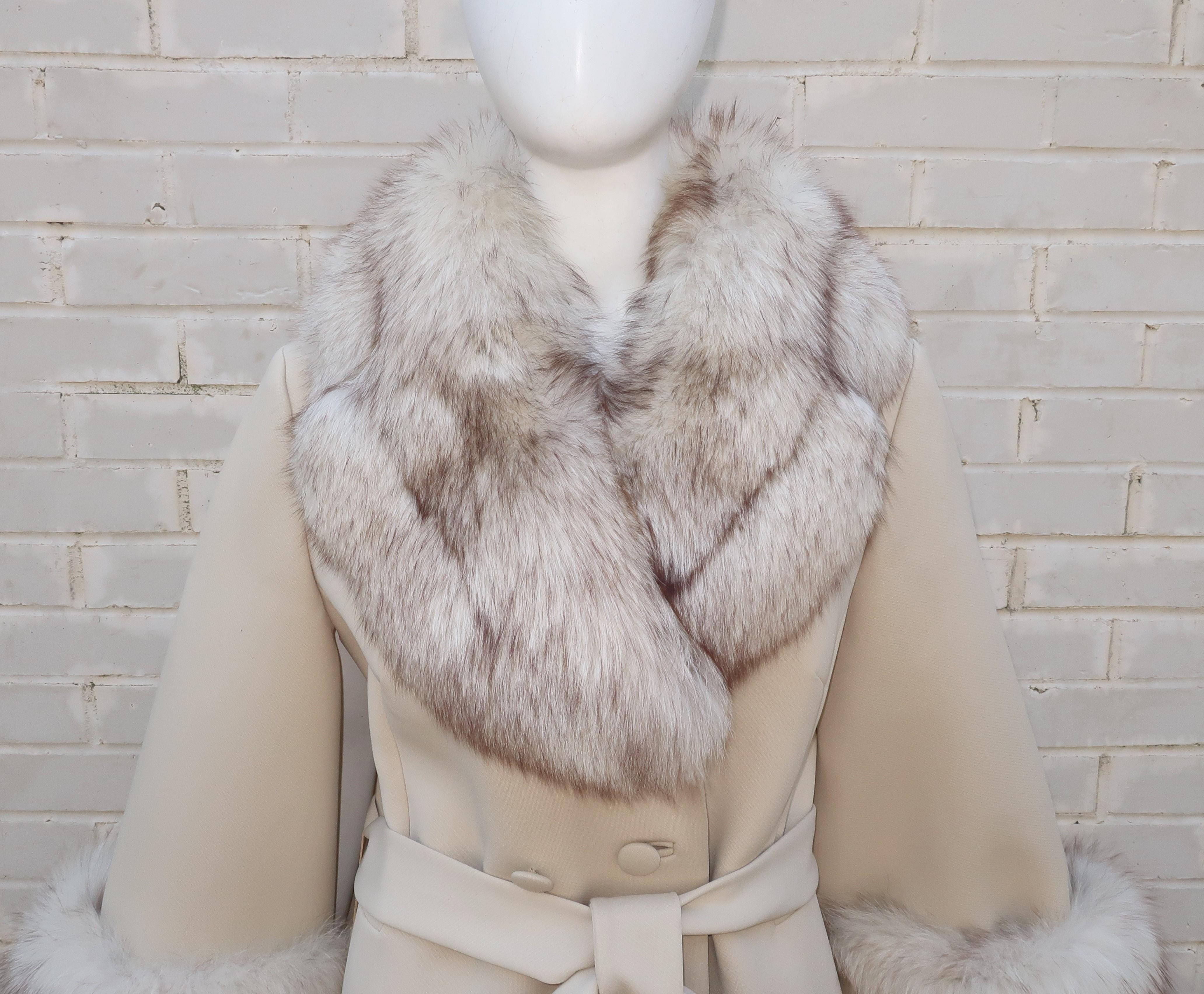 Glamour alert!  Designed under the artistic direction of Adolph Schuman for his company Lilli Ann, this 1960's vanilla white knit coat is trimmed in lush fox fur at the collar and cuffs.  The double breasted style sports front pockets and a tie sash