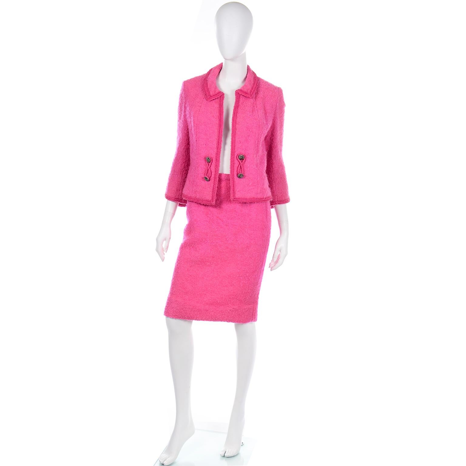 We think this hot pink Lilli Ann skirt suit is reminiscent of Chanel and we fell in love with it instantly! This 2 piece suit includes an open front  fully lined jacket with decorative buttons  and a chain at the hem for weight, and partially lined