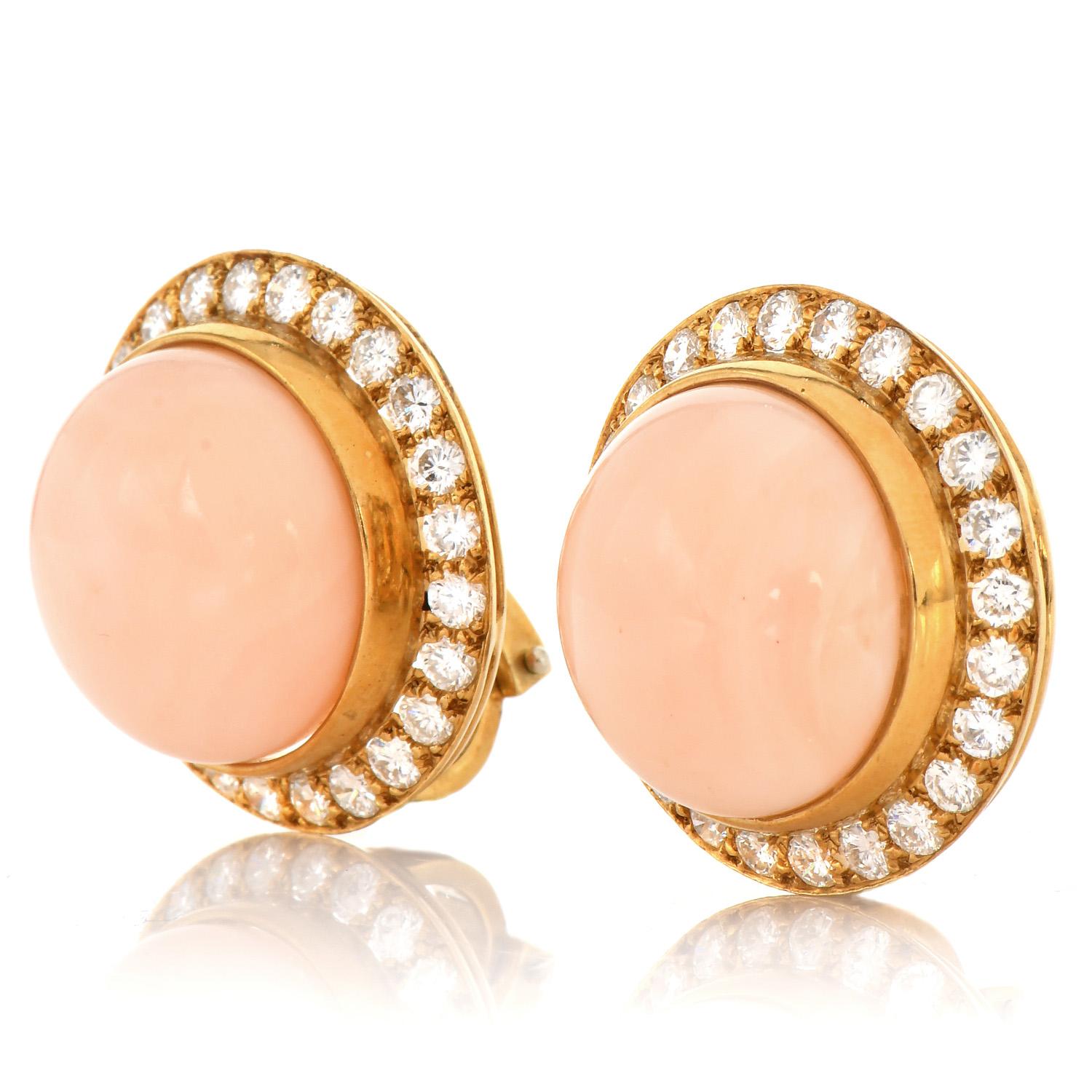 This Vintage 1980's earring features two large genuine Pink Coral gemstones with a Diamond Halo. 

This piece is crafted in solid 18K Yellow Gold. Signed Lilli, a famous jewelry designer in Florida in the 1980s.

The center is adorned by Two genuine