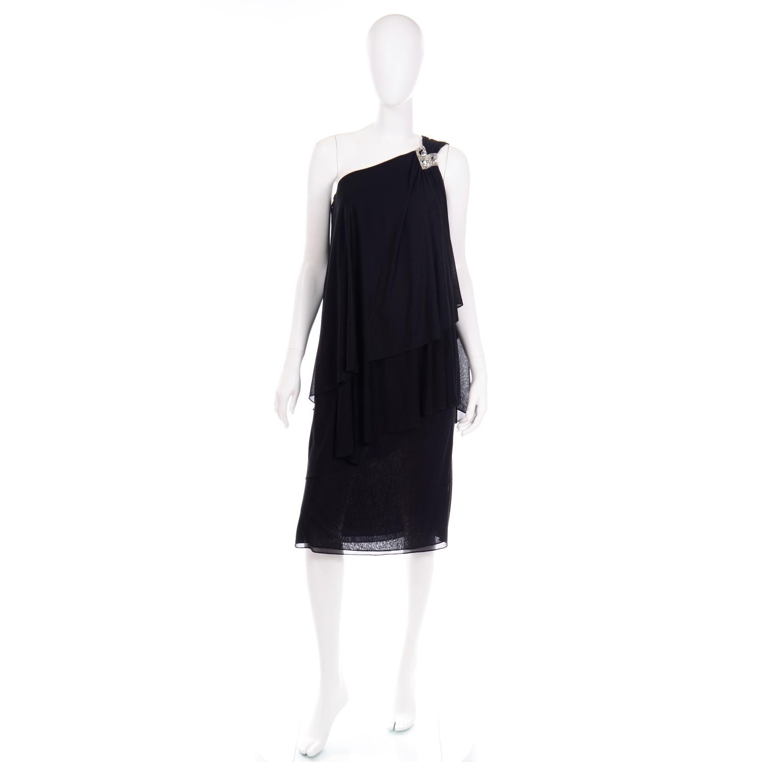 This is a Grecian style vintage 1970's Lilli Diamond black evening dress with one shoulder rhinestone detail. This pretty dress has several layers of the same semi sheer black silky lightweight jersey fabric with varying lengths in the layers. There