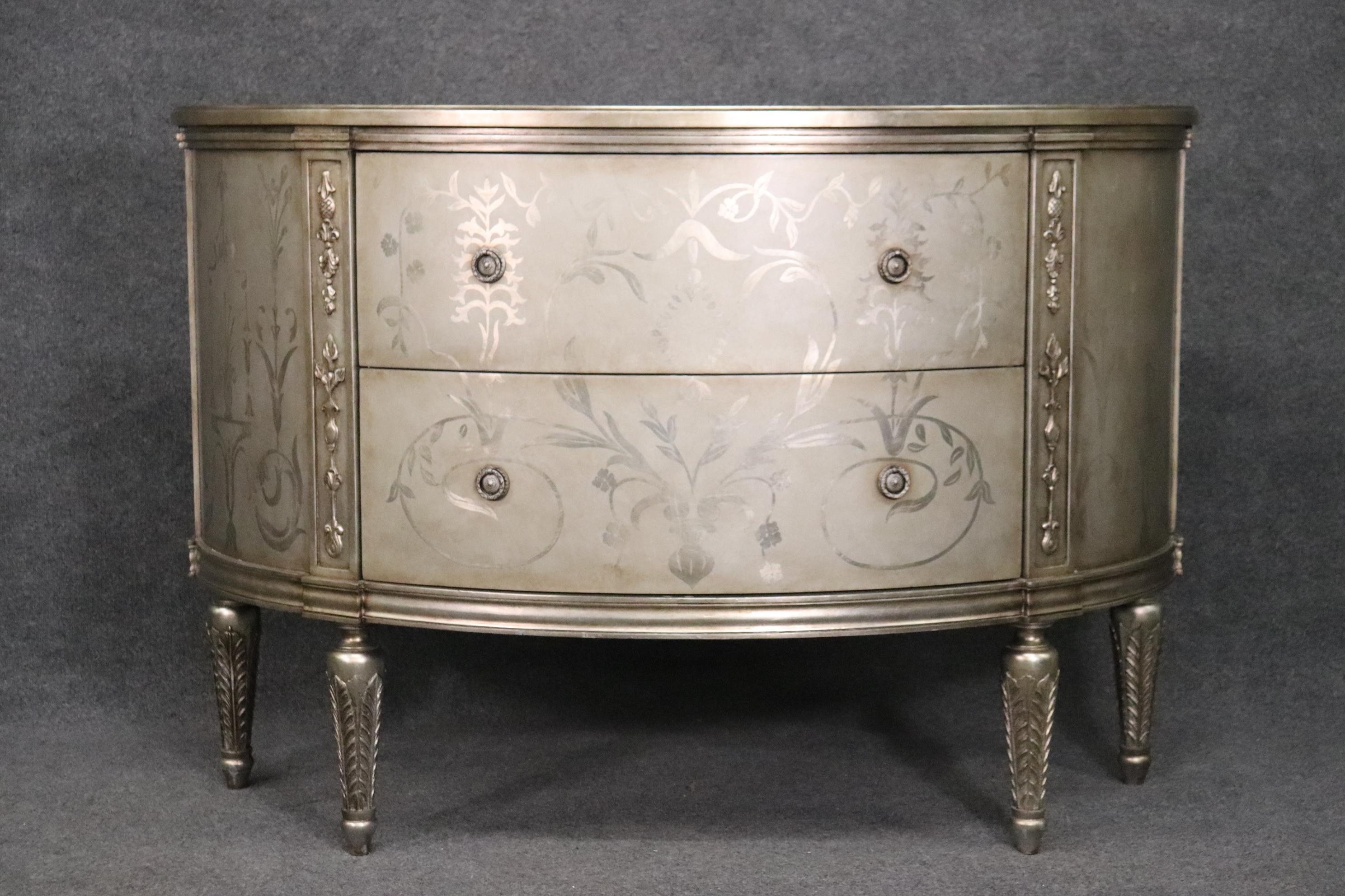 This is a beautiful Hollywood Regency style silver leaf (Not painted) commode with a nice luminous finish. The commode has some minor signs of age and use but is not very old so expect it to be in rather good shape. The commode measures 23 deep x 56