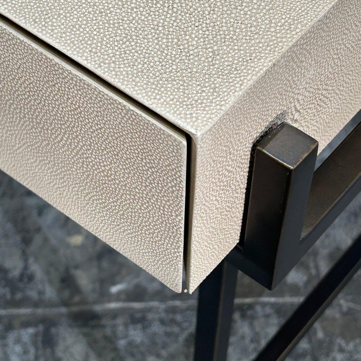 Elevate your workspace with the stunning Simone Faux Shagreen Leather Desk by Lillian August. Crafted with meticulous attention to detail, this desk features a luxurious shagreen finish that adds a touch of texture and sophistication to any room.