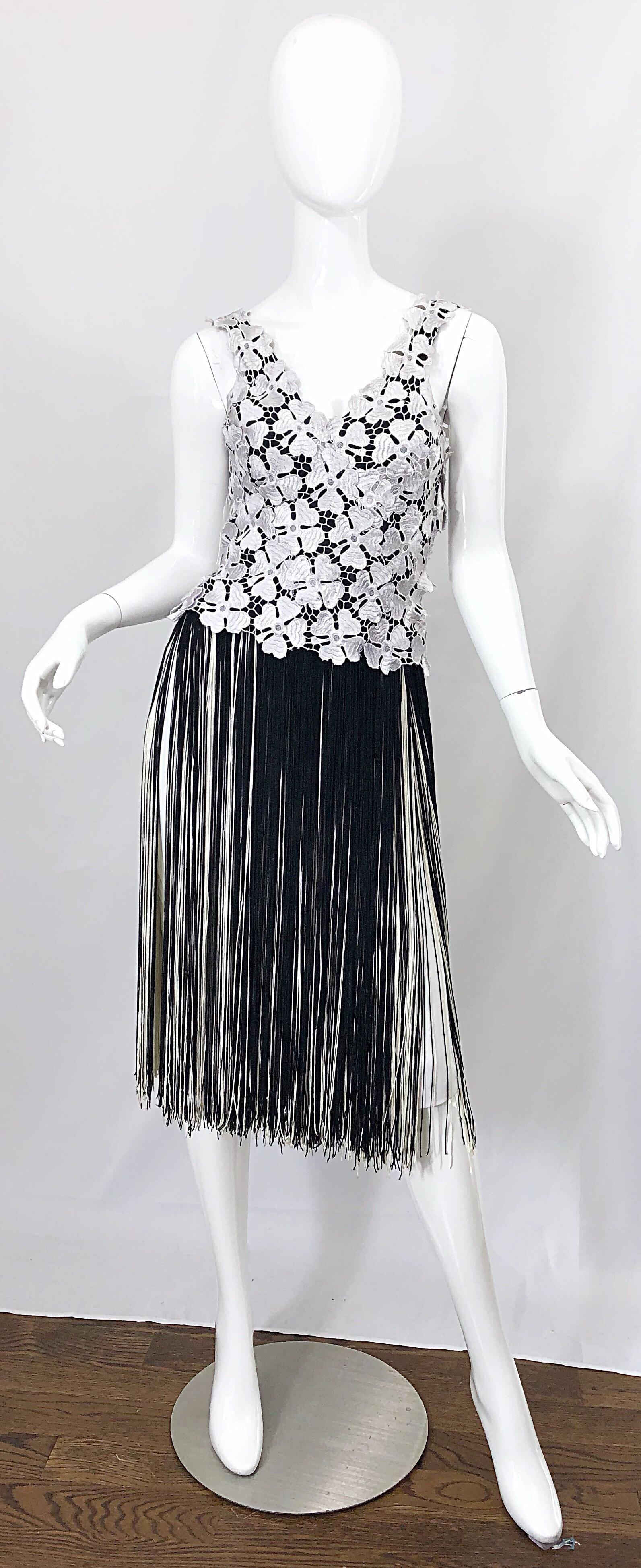 Amazing 70s LILLIE RUBIN black and white crochet flapper style cocktail dress! Features white hand crochet flowers over a black rayon bodice. White skirt features hundreds of layers of fringe in black and white. Hidden zipper up the side with