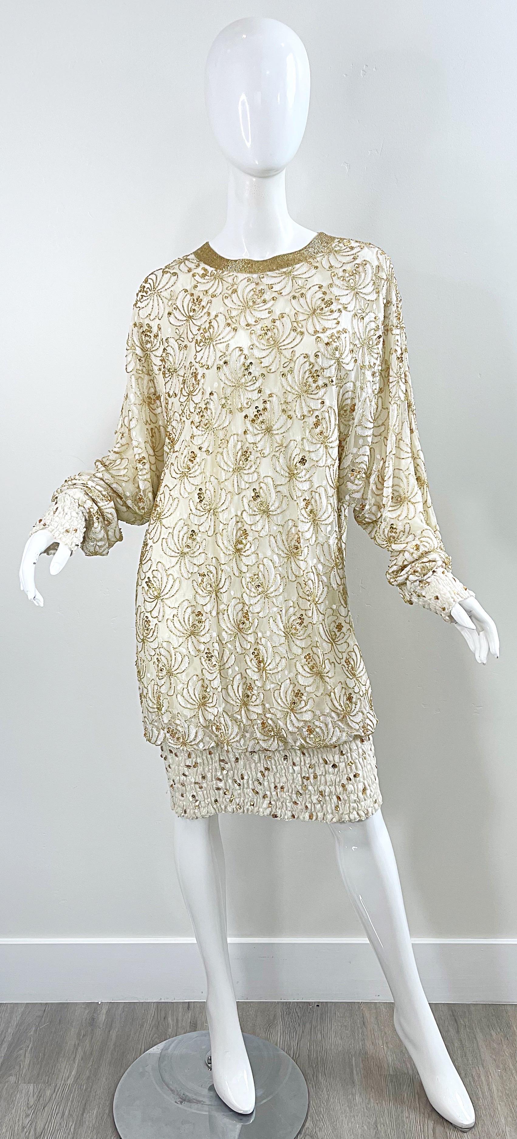 Beautiful late 80s LILLIE RUBIN ivory and gold rayon lace drop waist dress ! Features an ivory lace with thousands of hand-sewn gold sequins and beads. Long sleeve cuffs and hem have elastic and gold sequins. hidden zipper up the back with