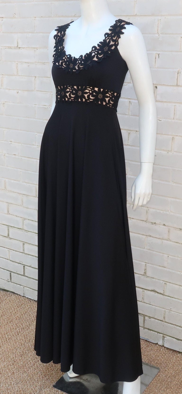 Get a sweet but not so innocent look with this black jersey maxi dress from Lillie Rubin's Collection 700 label C.1970.  The youthful style emphasizes curves with an empire construction and nude panels accented by floral appliques that create the