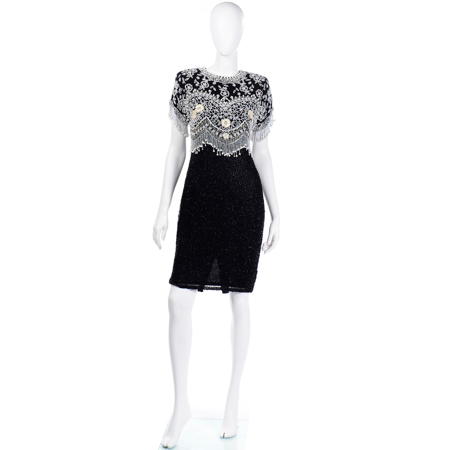 This is a beautiful vintage early 1990's Lillie Rubin fully beaded black silk evening dress. We love the intricate beadwork in shades of white, ivory, silver, and black throughout. The sleeves are a dolman style short sleeve with beaded pearl