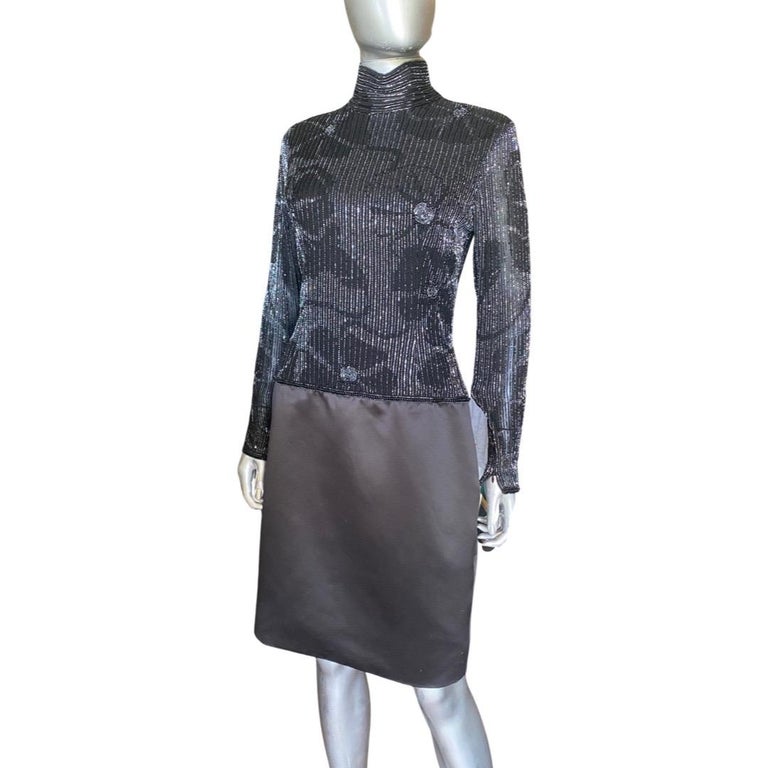 Such a chic dress made for Lillie Rubin Salon by Jeet , hand-beaded in India. The long sleeve high neck bodice is beaded with the most amazing, intricate bugle beads in a work or art pattern. Sleeves have zip at cuff. The black silk Charmeuse skirt