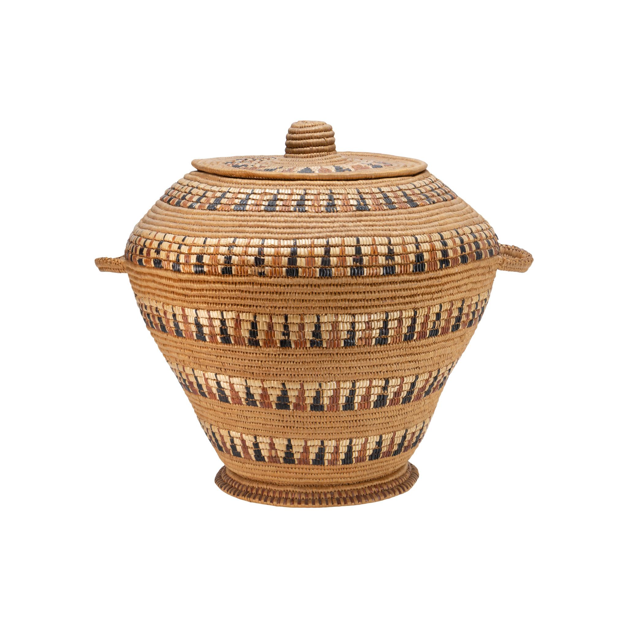 Lillooet lidded storage basket with polychrome imbricated design. Pedestal style. Traded for food in Washington, 5 miles from the Canadian border. Came to us from the granddaughter.

Period: circa 1900

Origin: Lillooet, WA

Size: 16