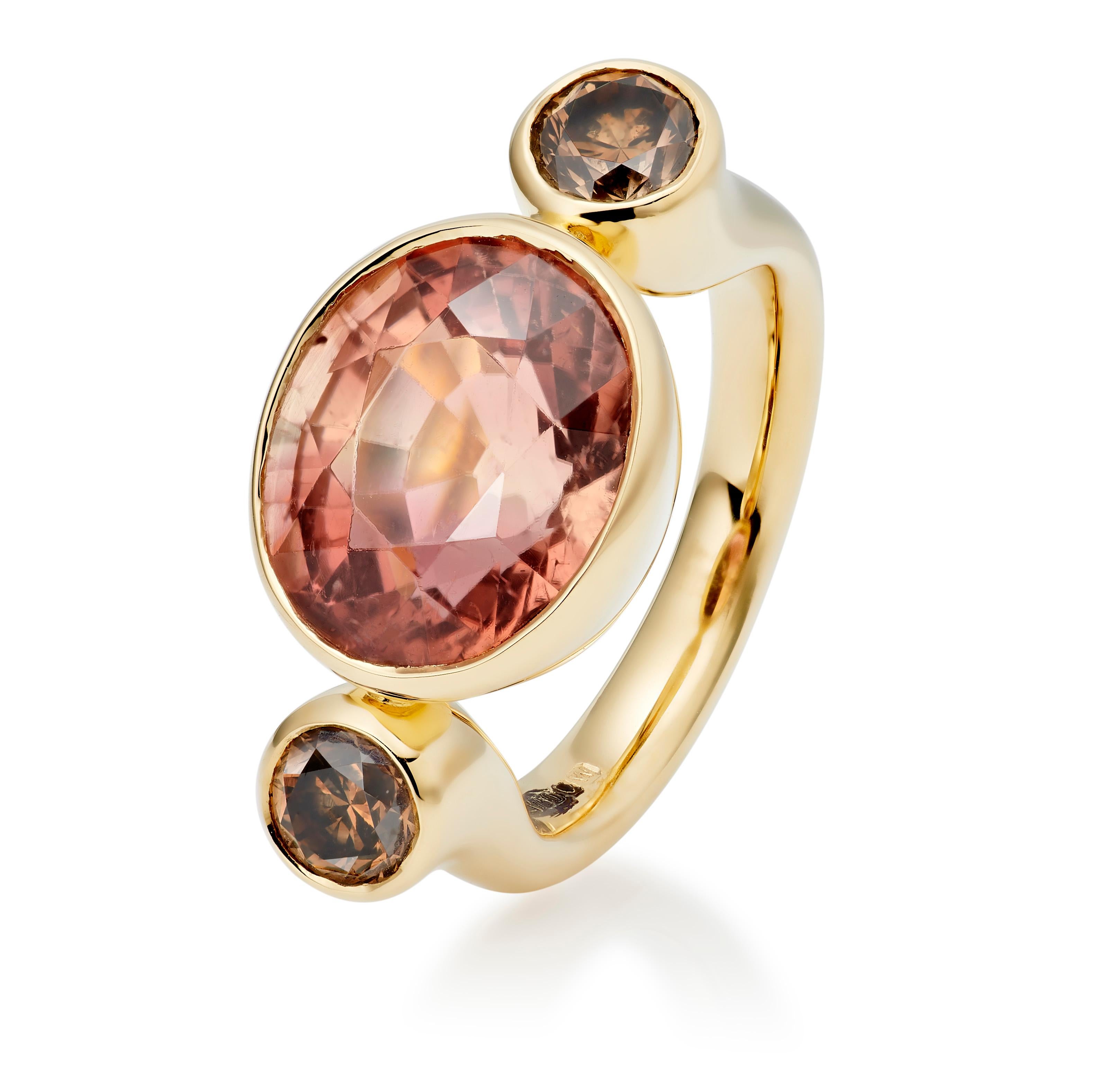 The Bon Bon is one of Lilly Hastedt's signature rings. The design on this ring follows the roundness of the gemstones.  The central Apricot Tourmaline has an oval faceted cut and is paired with sparkling round chocolate diamonds. The tones are warm