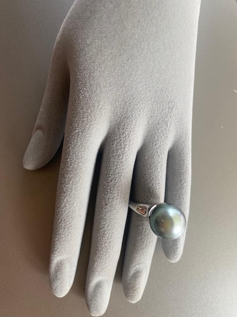 Black Tahitian Pearl Cocktail Ring set in Platinum.  This sculpture like ring can be admired even when you are not wearing it.  The dramatic blue grey pearl measures a fabulous 15 mm and has fantastic lustre showing pink and green overtones.  The