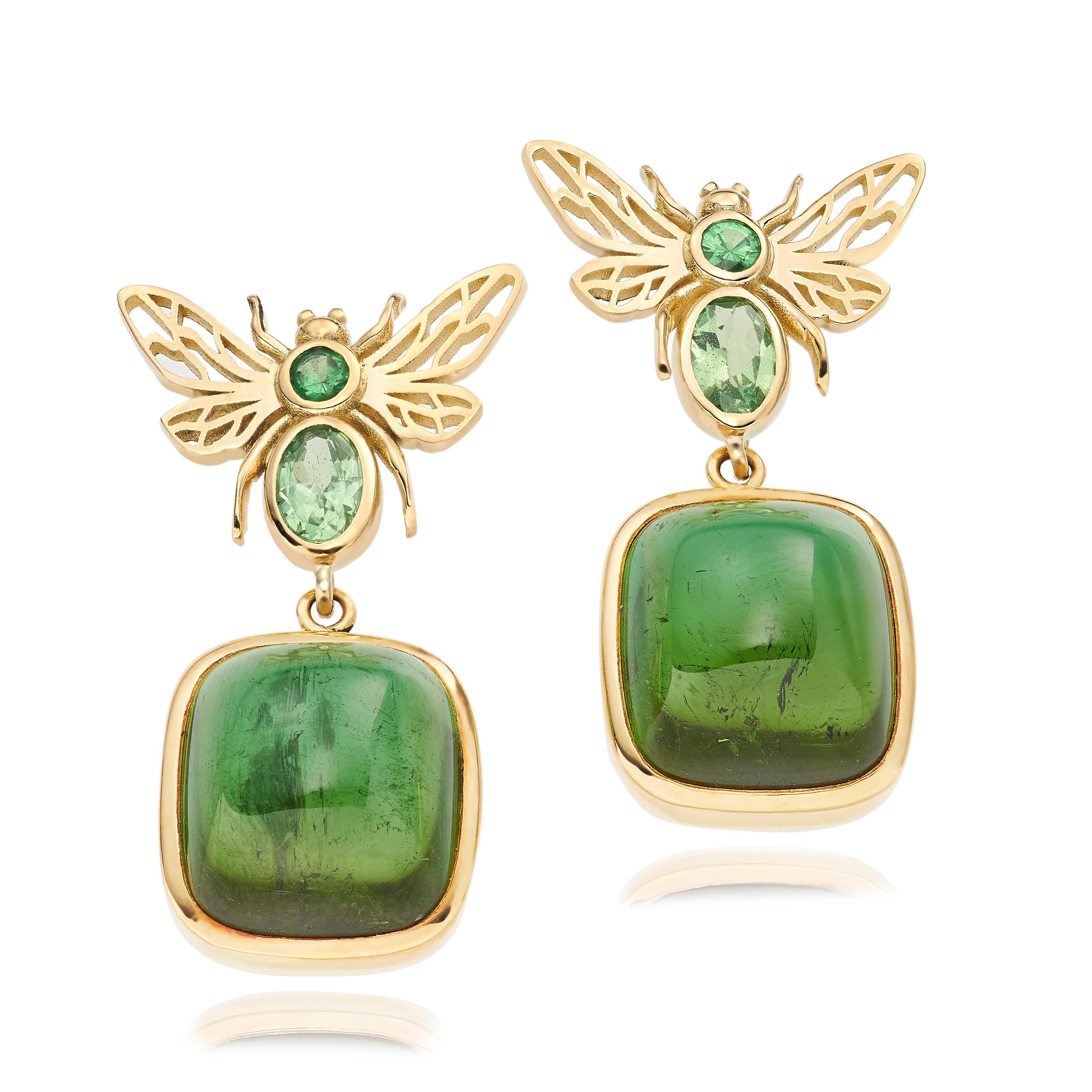 A pair of statement cocktail earrings from Lilly Hastedt's Fauna collection.  The earrings are set with sparkling Tsavorites and green Tourmaline cabochons. The cabochons are detachable so the bees can be worn on their own. The gemstones are of the