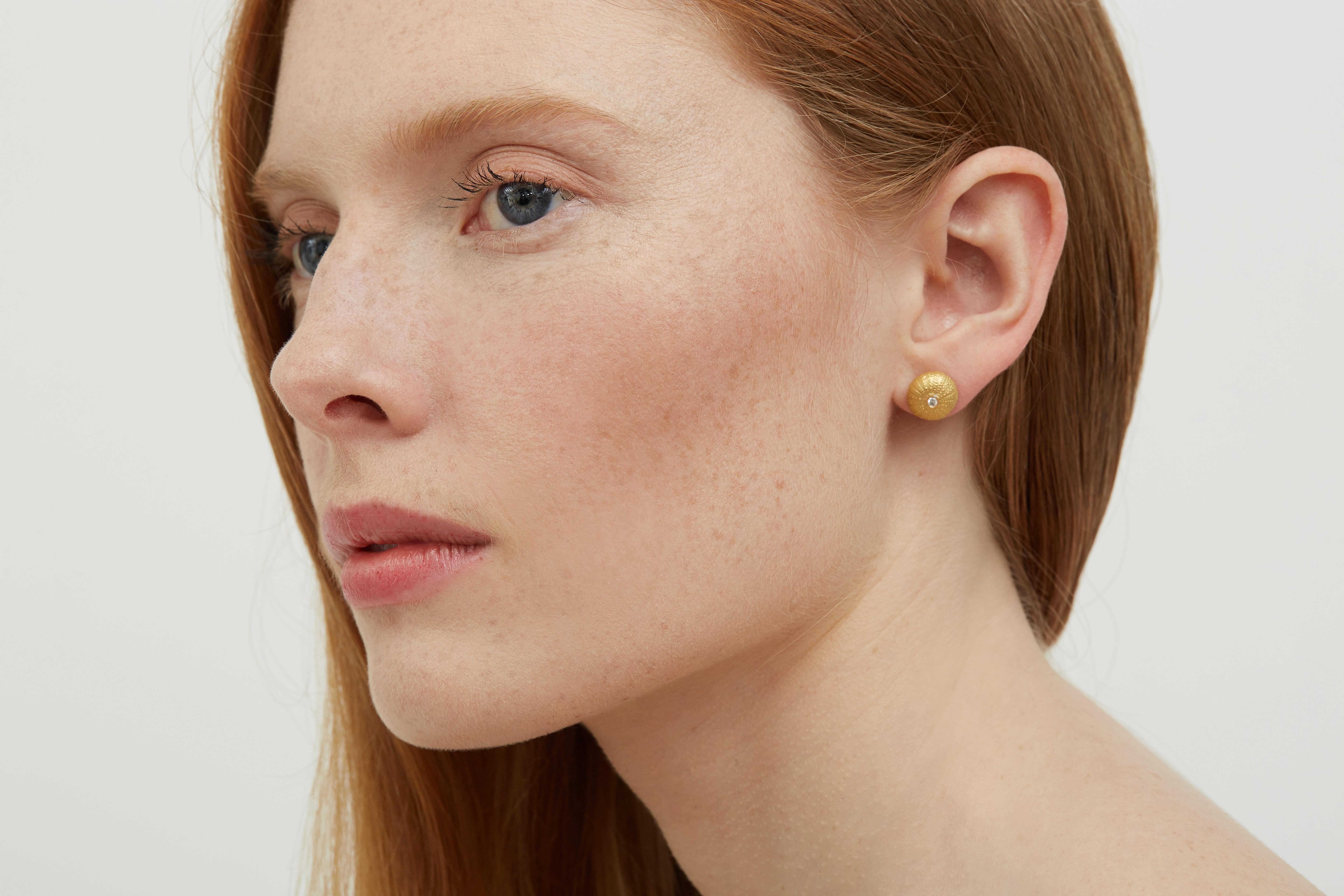 These Lilly Hastedt earrings feature dazzling Diamonds embedded in 18 karat yellow Gold. Inspired by the sea, these classic studs earrings mirror the beauty of textured sea urchins and can liven up any outfit with a touch of luxury.  Made in London