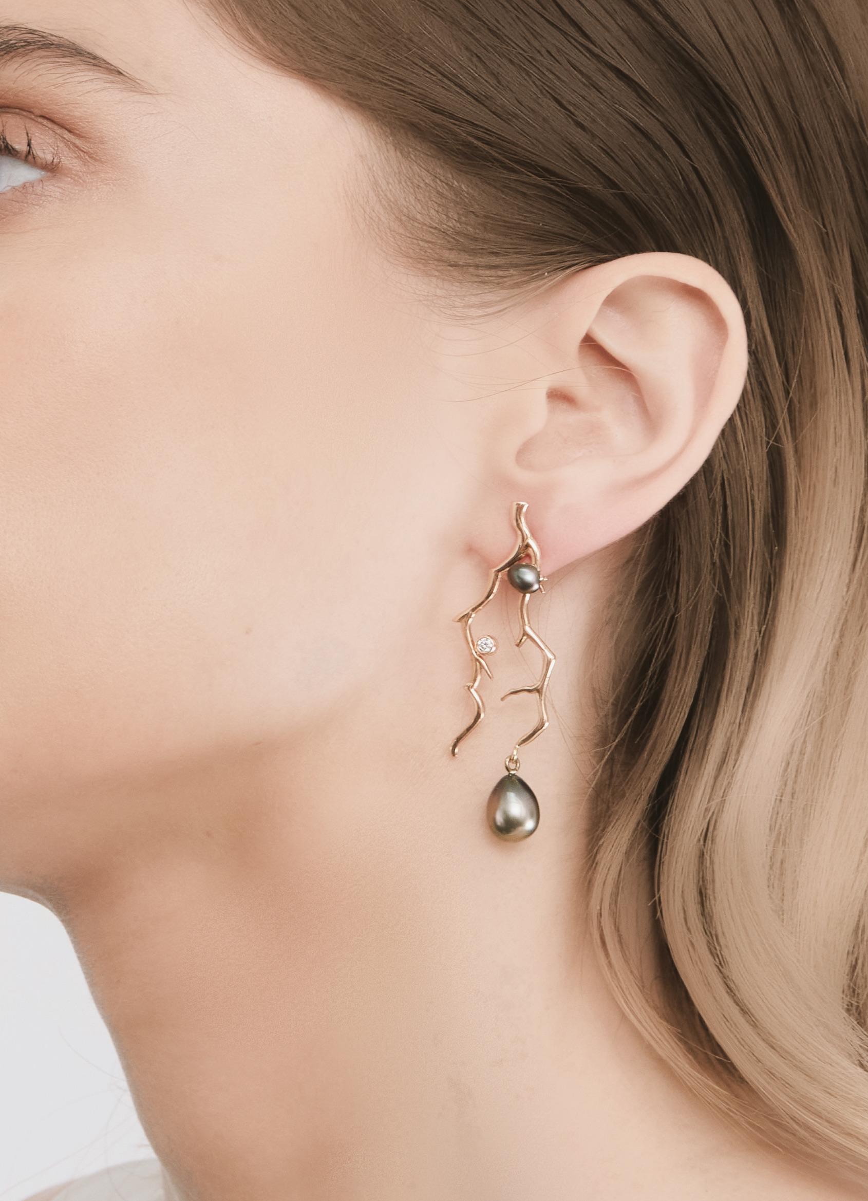 A Lily Hastedt Signature pair of chandelier earrings with Tahitian Black Pearls and Diamonds in 18 Karat rose Gold.  These earrings have an asymmetric design inspired by coral twigs and 'mirror' each other. The coral branches are embellished with