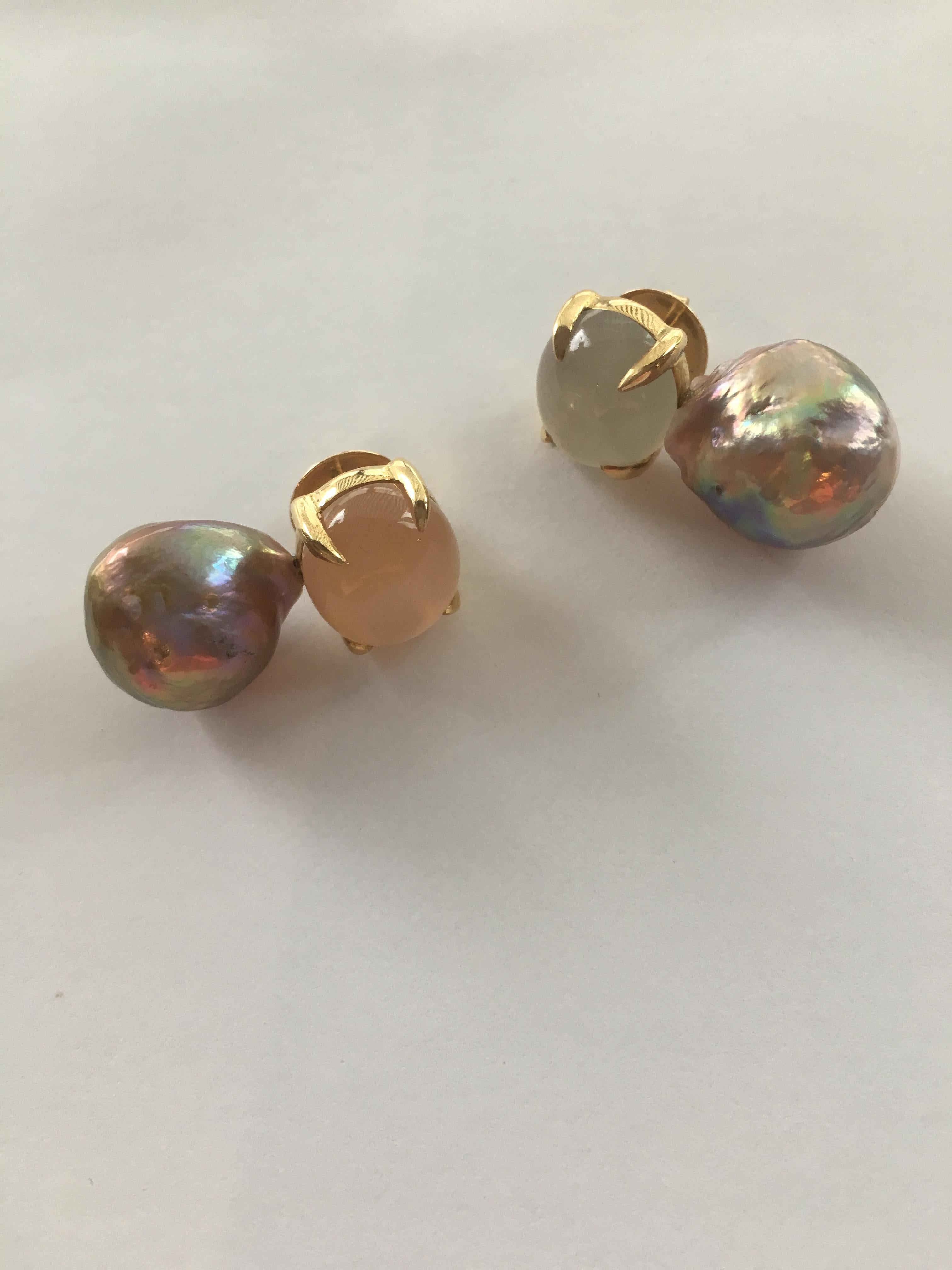 A pair of striking moonstone and ming freshwater pearl earrings. They are paired with metallic iridescent baroque freshwater pearls and set in 18 karat yellow gold.   Having the moonstones in different colour makes them interesting and unique