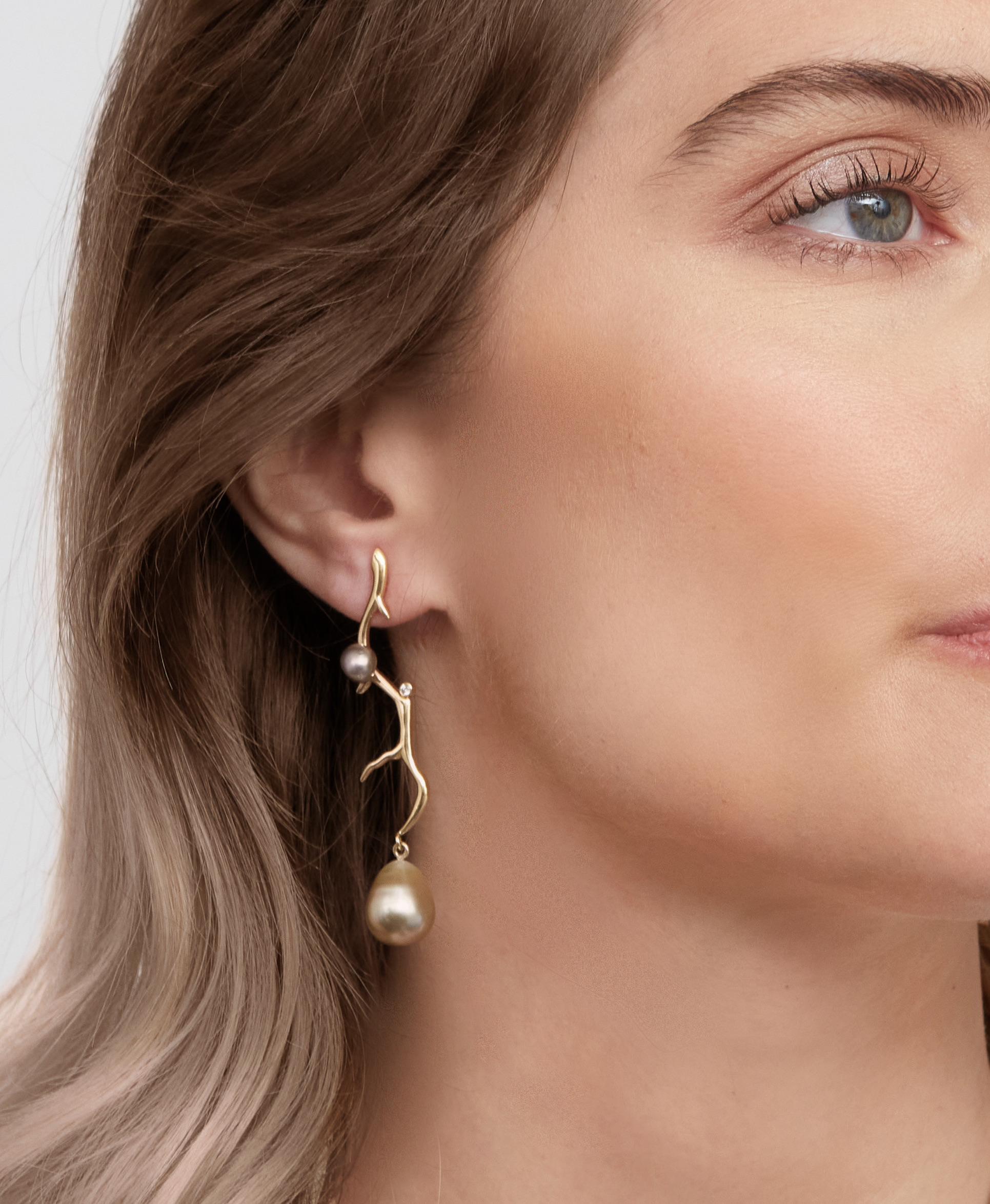 A Lily Hastedt Signature pair of  earrings with Tahitian Black Pearls and Diamonds in 18 Karat yellow Gold.  These earrings are based on coral twigs from Lilly's 'Coral Inspirations' collection and 'reflect' each other in an asymmetric way.  The