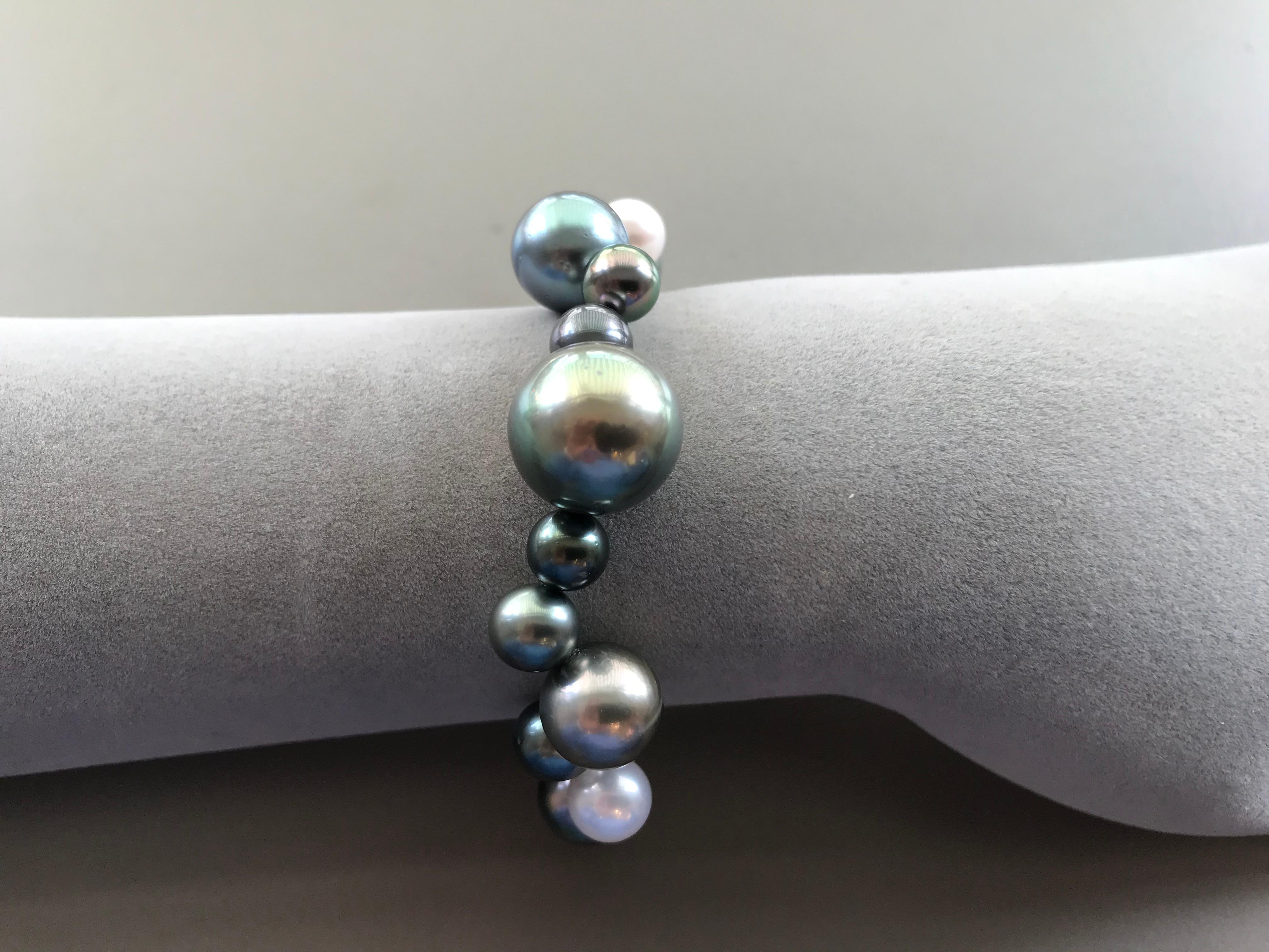 A striking bracelet with different hues, colors and sizes Tahitian and South Sea pearls.
Classic pearls with a contemporary twist.  The clasp is hidden so you see only pearls when wearing it.

Natural color Tahiti pearls not dyed.

8 - 15 mm pearls
