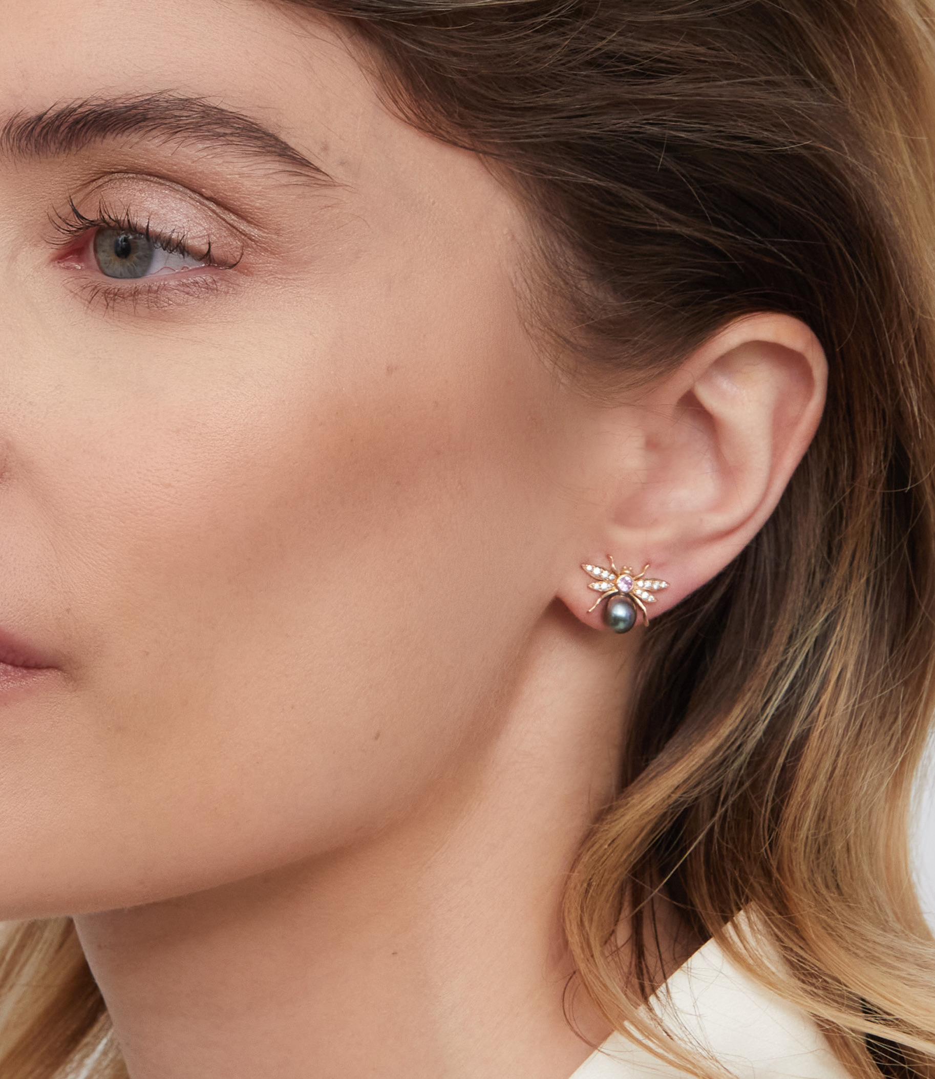 A pair of whimsical stud earrings from Lilly Hastedt's Fauna collection.  The insects are set with sparkling  lavender and pink Sapphires. One of the earrings has a black Tahitian pearl and the other one a lavender Sapphire and both are set in 18