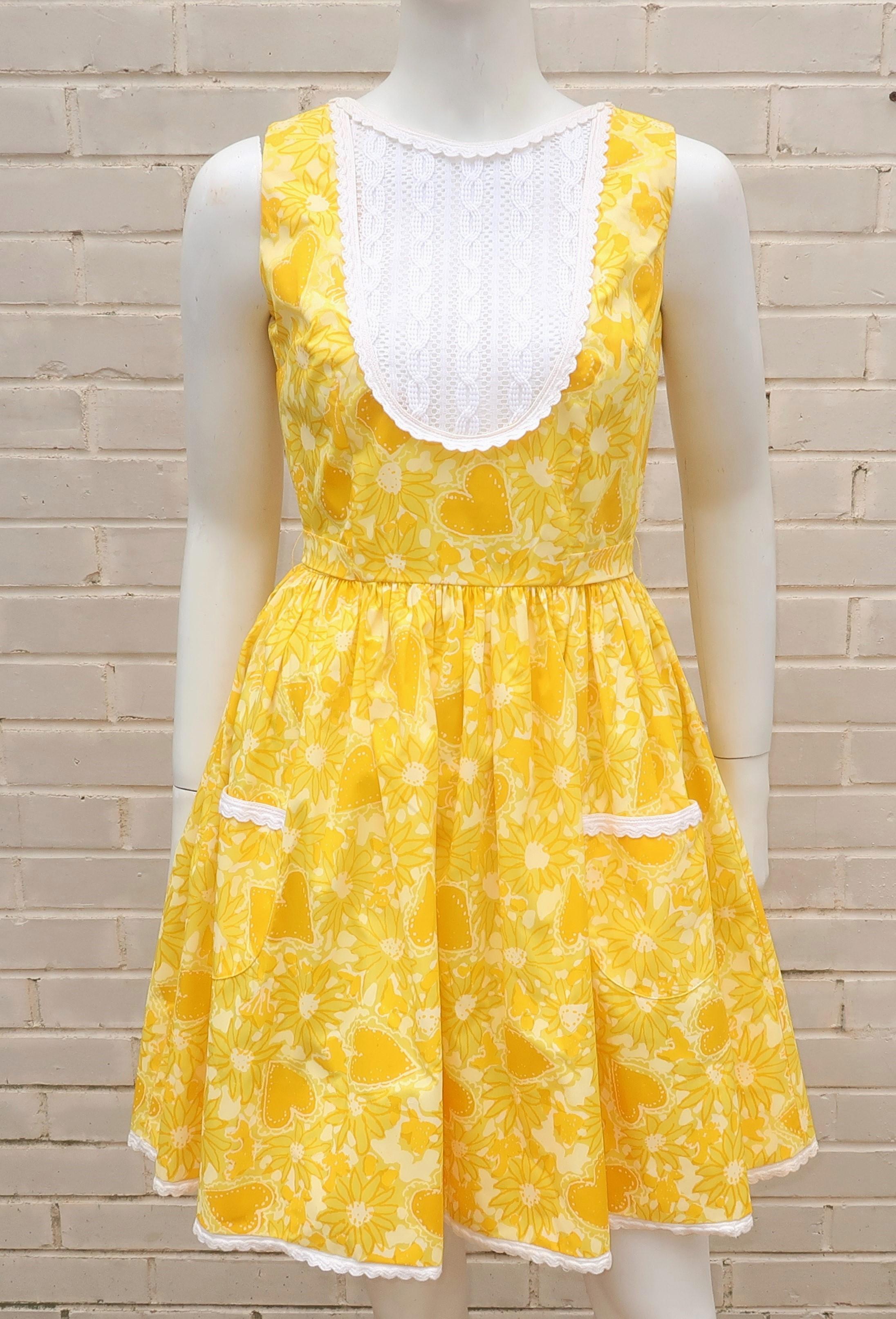 1960's Lilly Pulitzer yellow sundress with a 'flower power' daisy and heart print in a cotton blend.  The dress zips and hooks at the scoop back with a built-in tie at the waist.  It is a flirty look for Pulitzer's otherwise preppy designs mostly