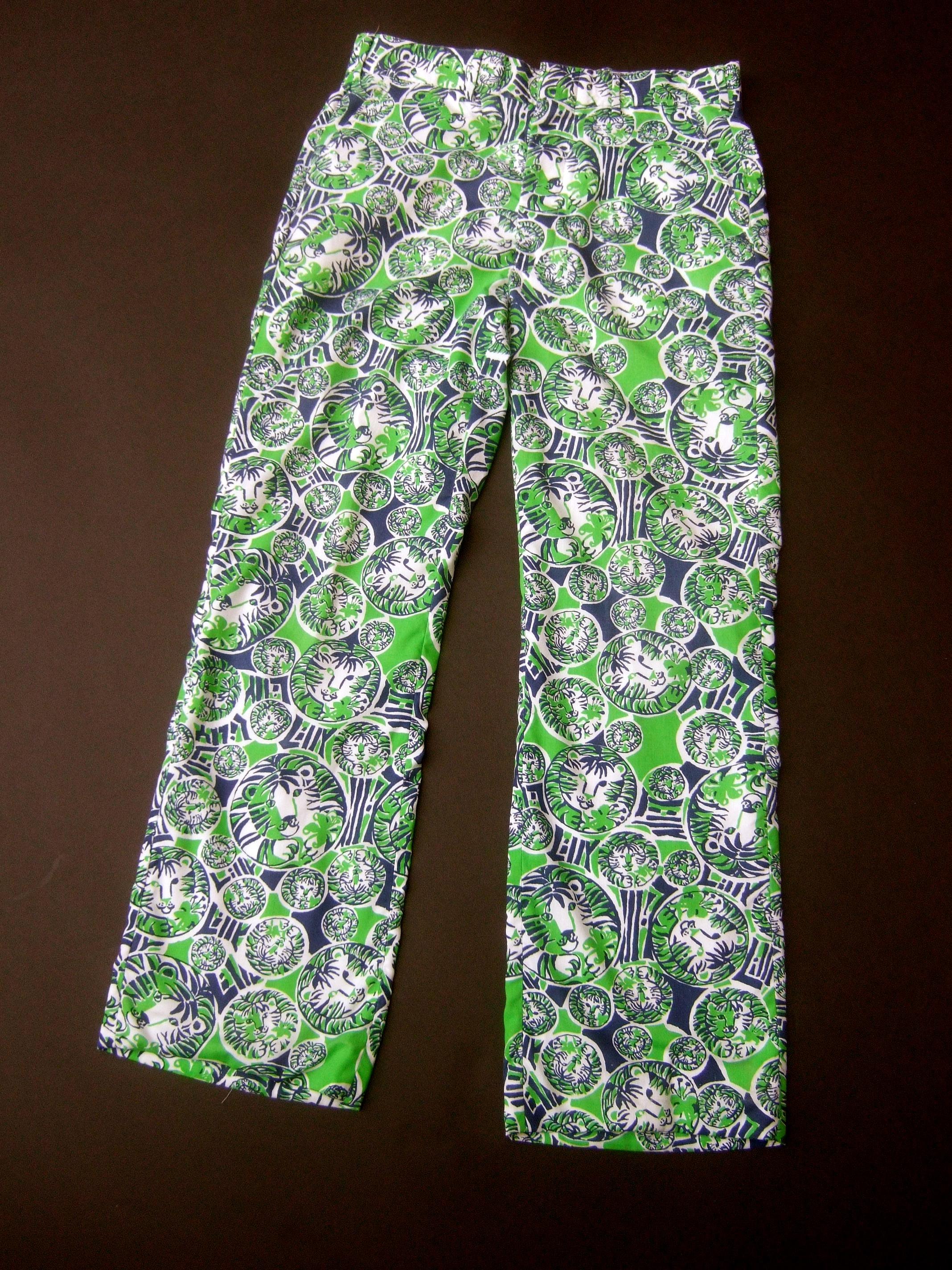 Lilly Pulitzer Men's tiger print trousers c 1970s
The preppy resort style men's trousers are designed
with Pulitzer's iconic tigers set in a vibrant jungle
print background

The bold lime green, dark blue & crisp white color
block graphics make a