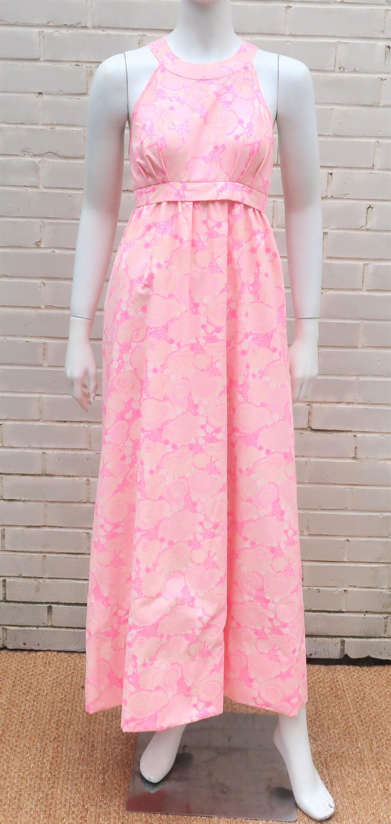 Pretty in pink!  1960's Lilly Pulitzer pink halter dress in a cotton blended fabric with a snail print.  The dress zips and hooks at the back with crisscrossed buttoned straps that offer three adjustable sizes.  The charming print incorporates
