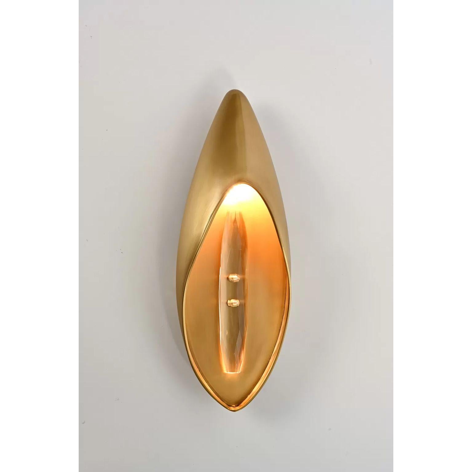 Lilly Wall Sconce by Dainte
Dimensions: D 9 x W 14 x H 40 cm.
Materials: Crystal and brass. 

The Lily Collection is minimal, modern, and textured. It embodies the lily flower’s pure beauty and is made of textured brass. The collection illustrates