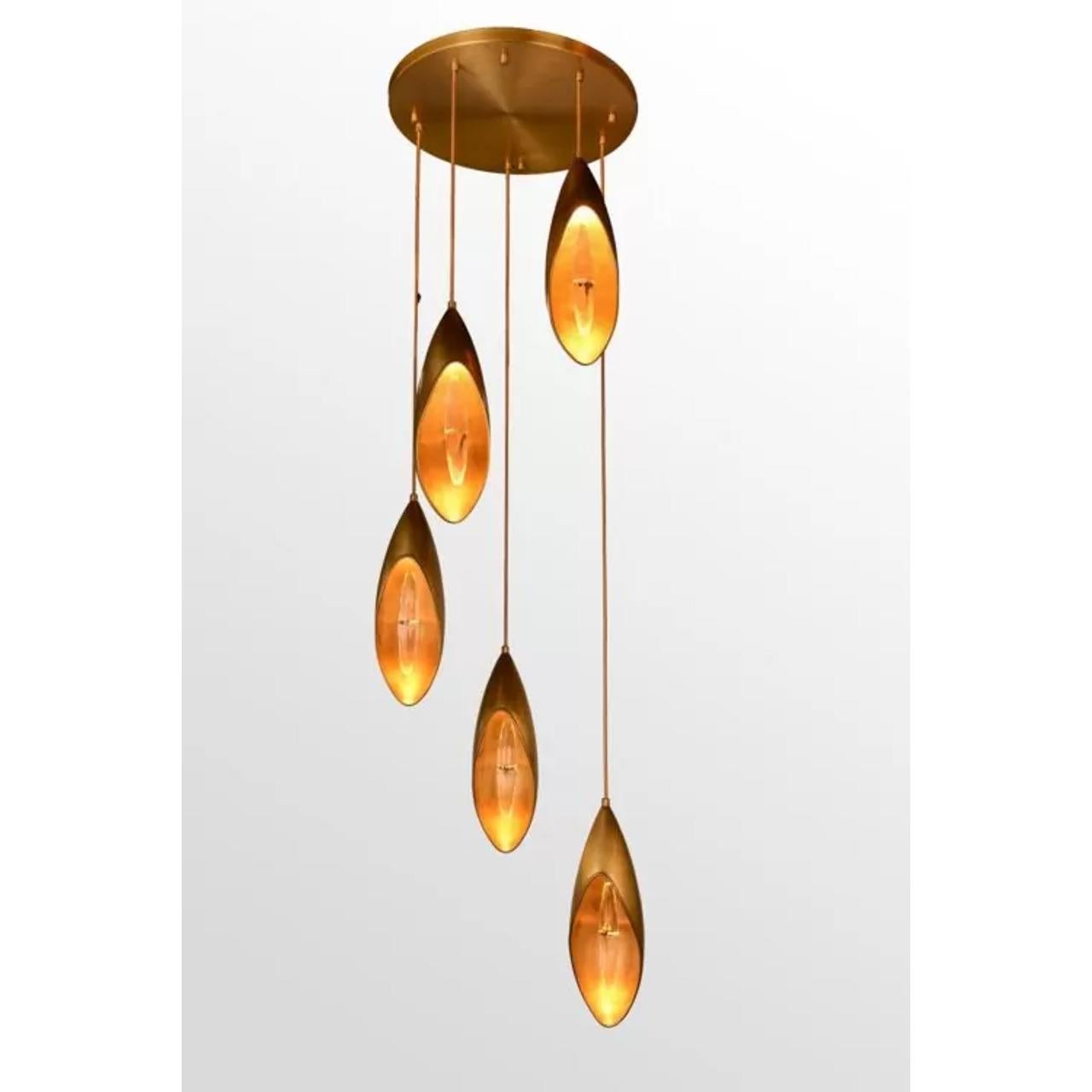 The Lilly Chandelier beautifully captures the essence of the lily flower in a seamless blend of nature-inspired design and minimalistic elegance. Its textured brass body and crystal accents reflect light in a mesmerizing way, adding a warm, inviting