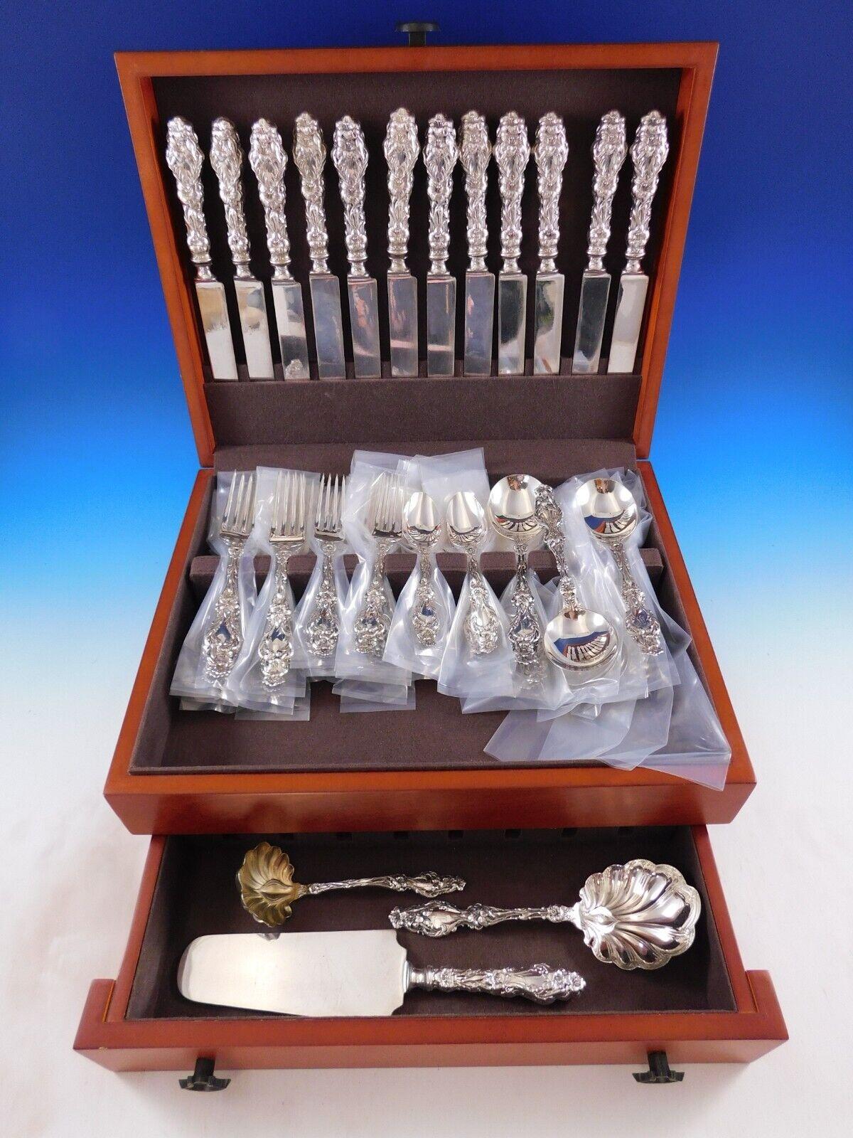 Dinner Size Lily by Whiting Sterling Silver Flatware set - 64 pieces. This set includes:

12 Dinner Size Knives with fabulous early hand cast handles and Blunt plated blades, 9 3/4