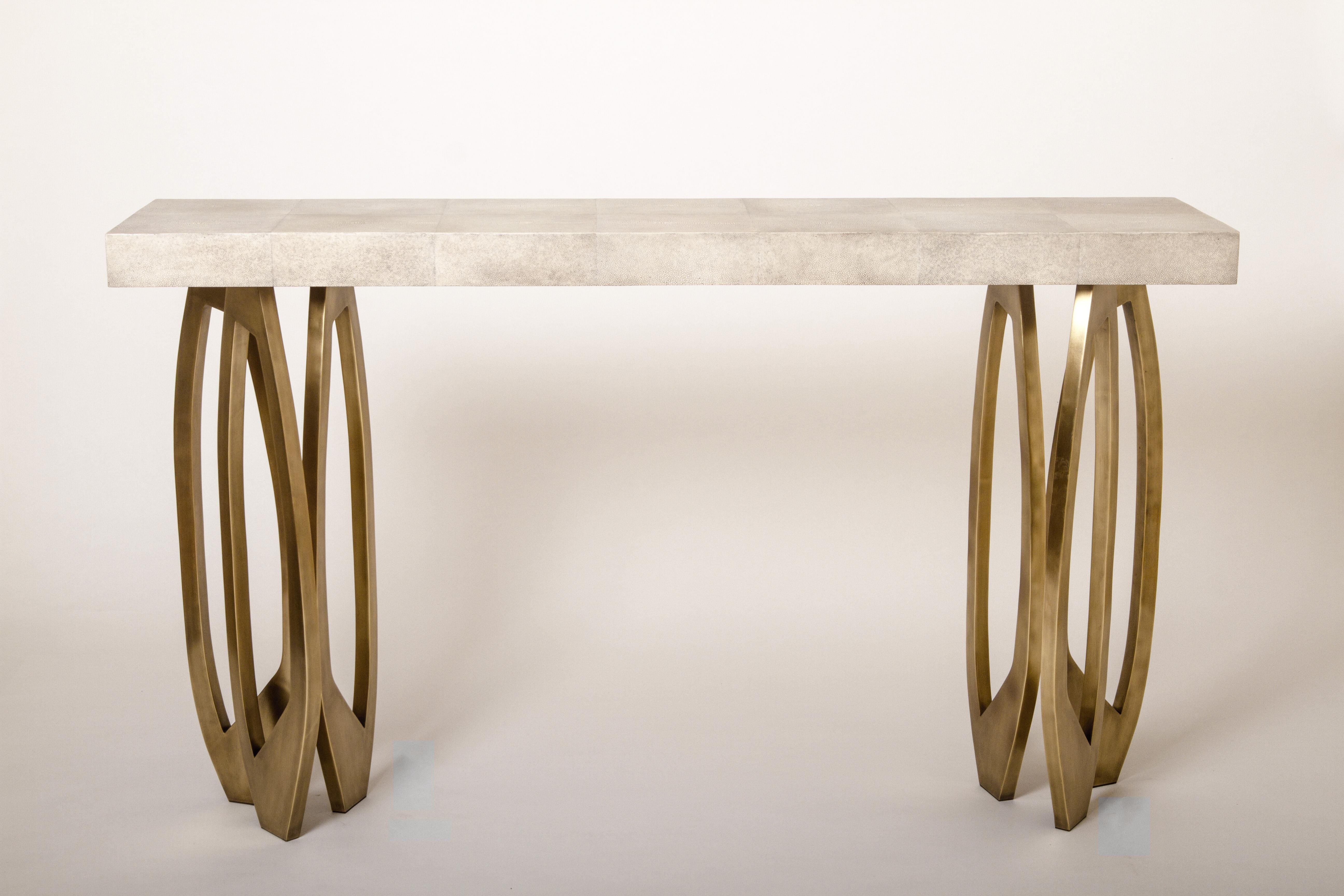 The lily console in cream Shagreen by R&Y Augousti makes for a dramatic statement piece in any space. The shagreen top sits on a cluster of sculptural bronze-patina brass inlaid legs. Custom color and sizing available on request. Available with palm