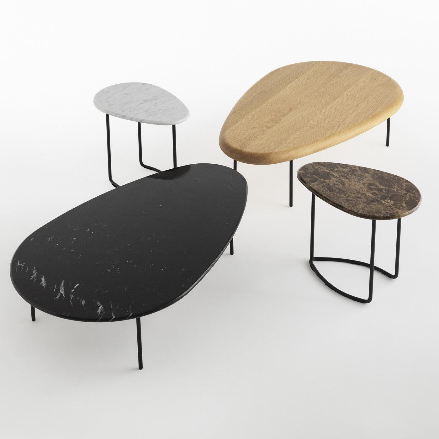 The concept of customization is at the basis of the Lily Collection of tables designed by Marc Thorpe, inspired by the shape of the flowering plant Nymphaeaceae. Available with fabric, wood, and marble tops, the featured table has a striking black