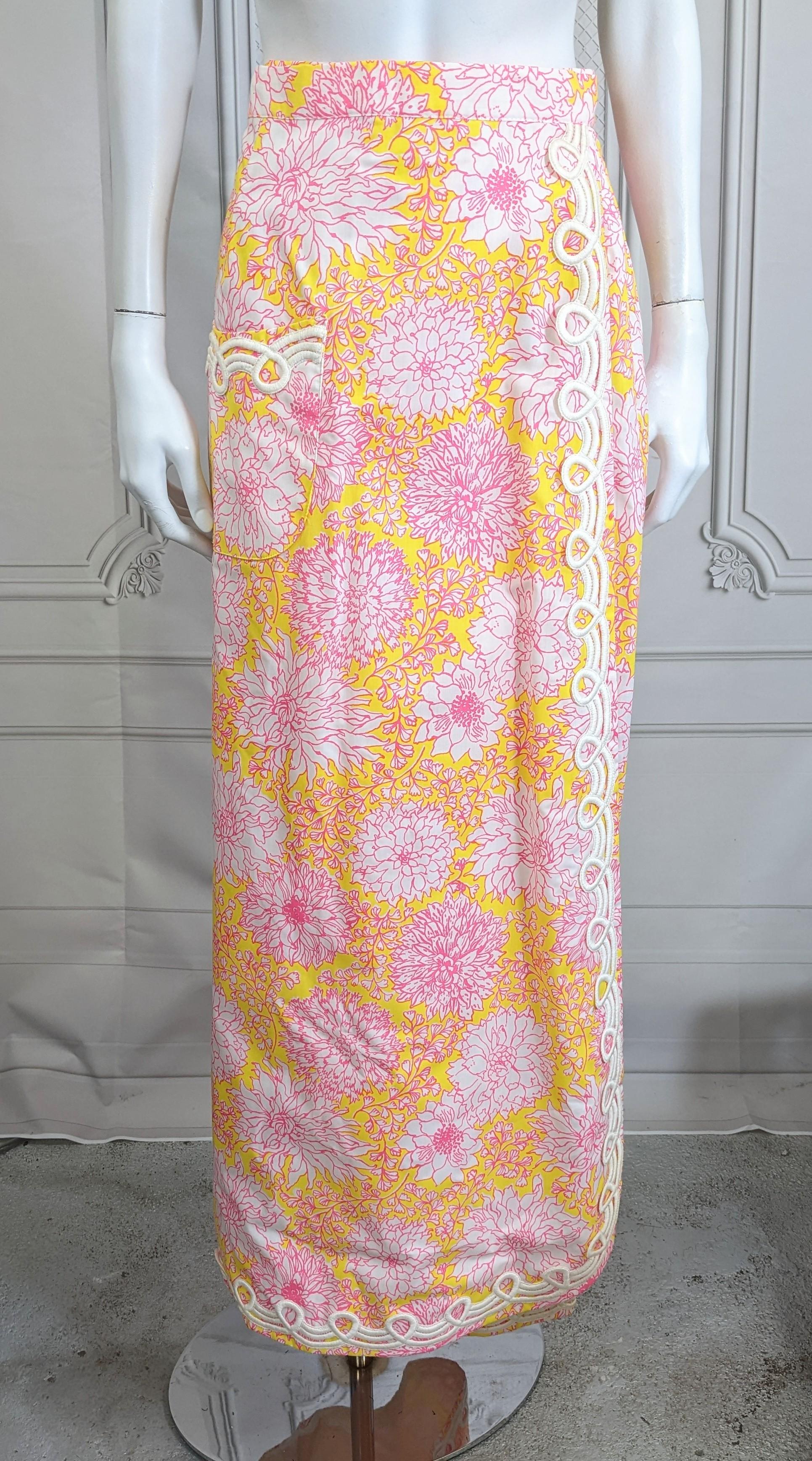 Festive Lily Pulitzer Soutache Trimmed Flared Maxi Wrap Skirt from the 1960's. Vibrant pink and yellow floral print with lining. One patch pocket with soutache edge on hem as well.
Size Medium, 1960's USA. 