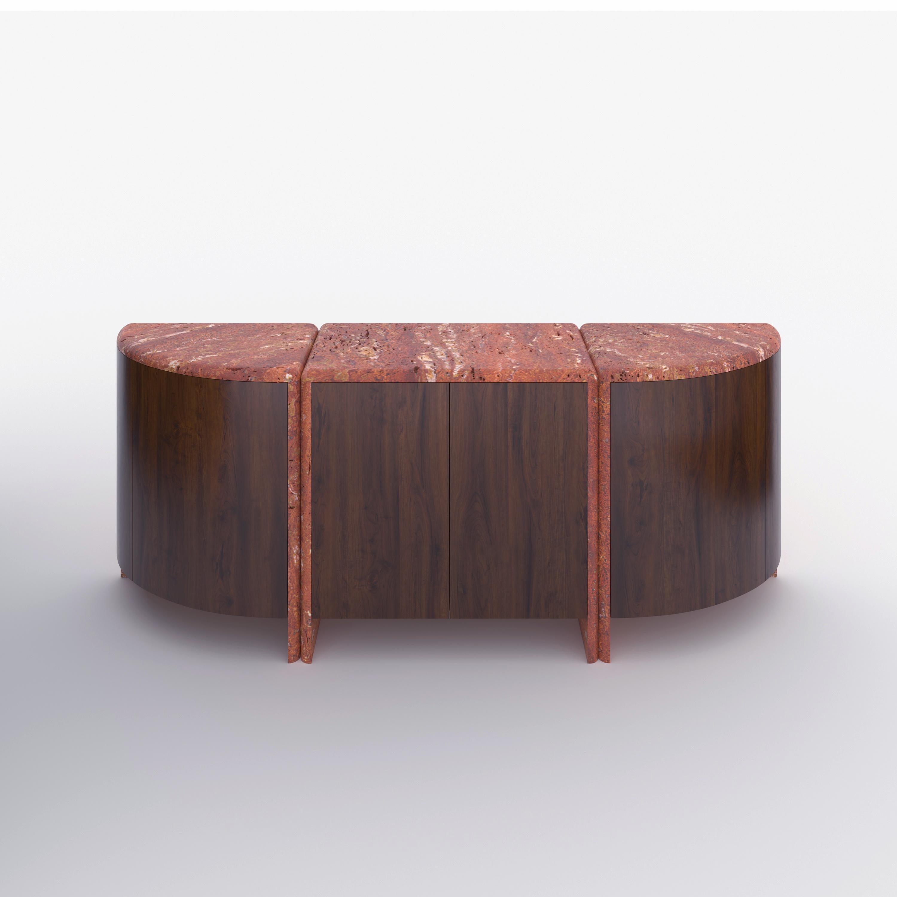 A credenza inspired by giant water lily pads and their curled rims, handmade out of 30 mm thick honed unfilled red Travertine with rounded, juxtaposed edges and Canaletto Walnut.
Available in any size and material of choice.

About