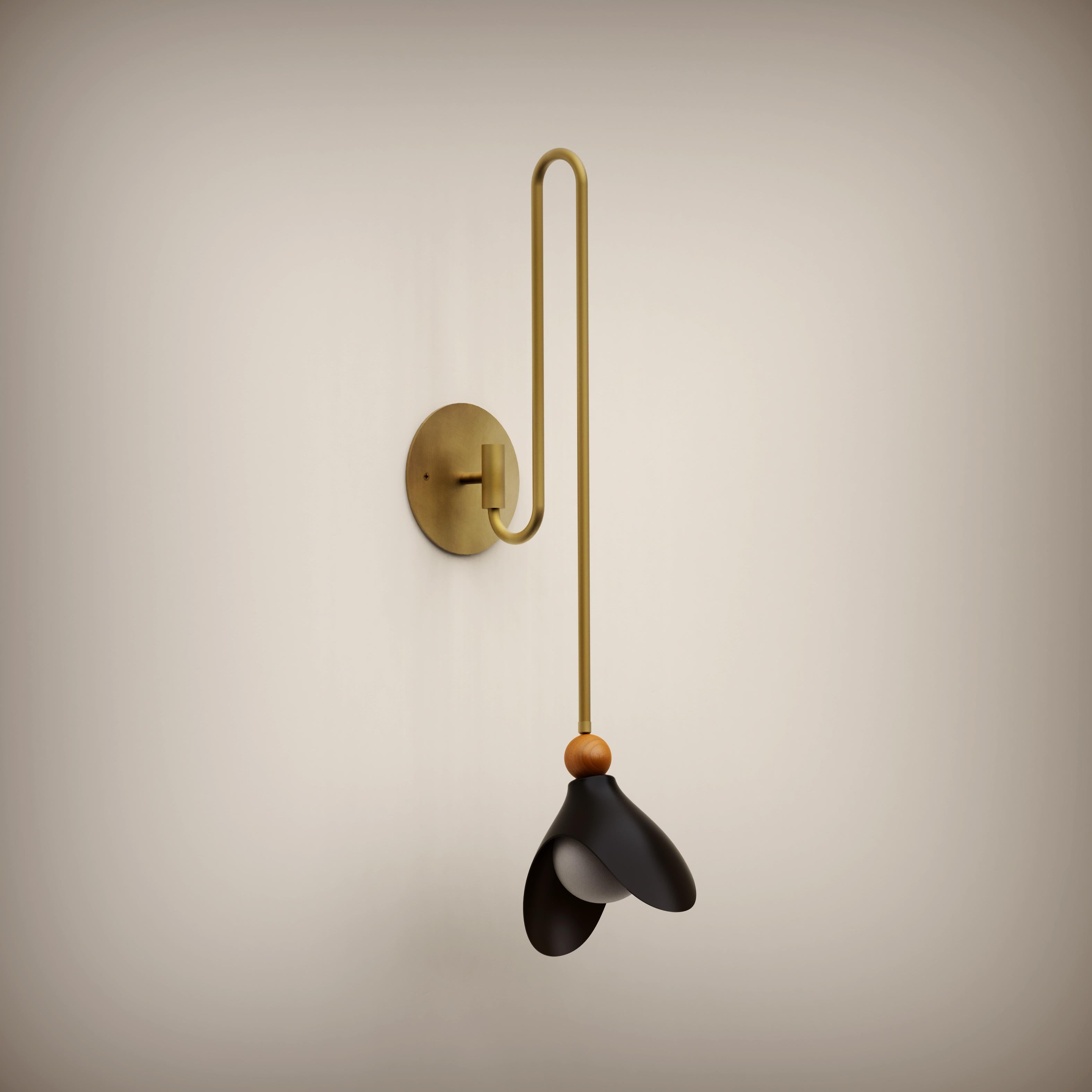 
Part of the Ginger Curtis x Blueprint Lighting Collection, 2024.

Lily is inspired by the graceful interplay between a brass hook and a gently hanging garment. Evocative of both elegance and simplicity, this fixture mirrors the graceful form of its