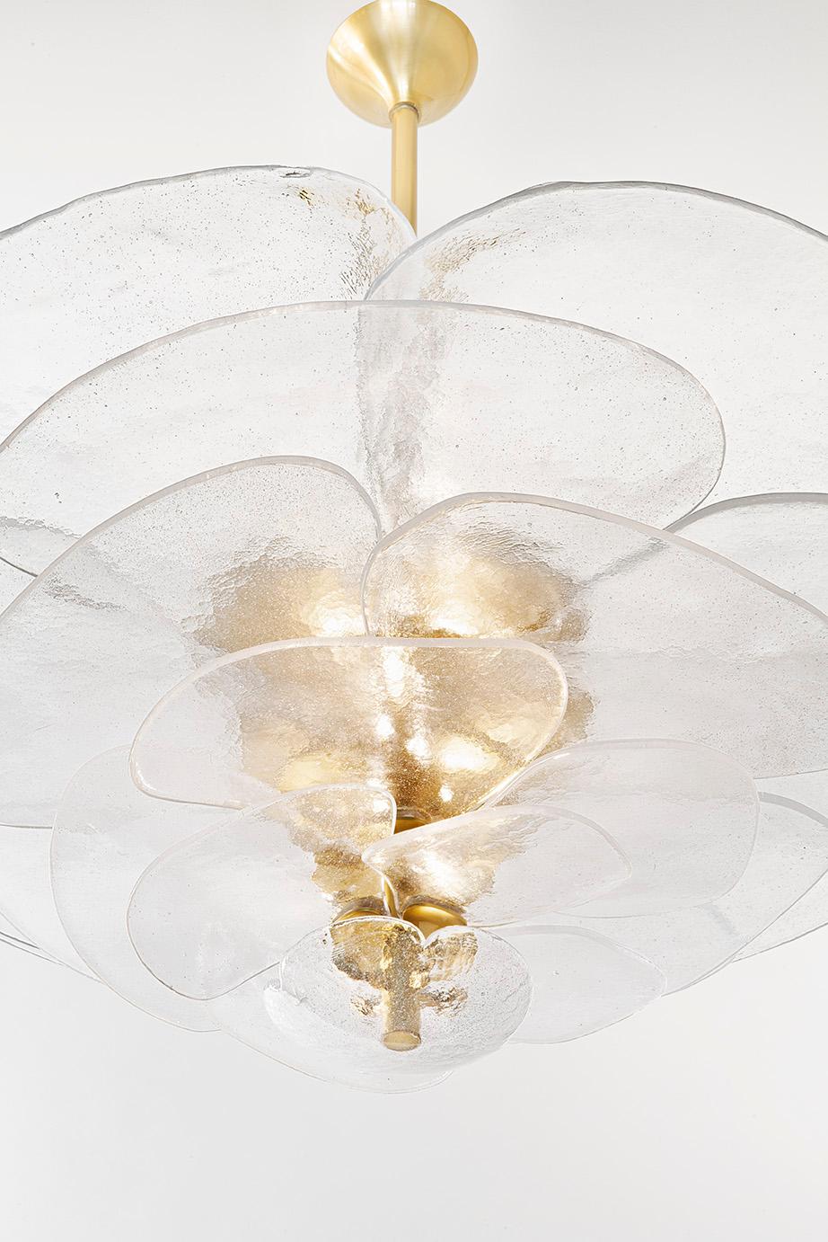 Textured glass chandelier composed of individuals bubbled petals mounted on a brass structure, in the shape of a lily pad flower that diffuses light. 
The chandelier is composed of 24 spotlights.
All is crafted in northen Italy near Venise.
