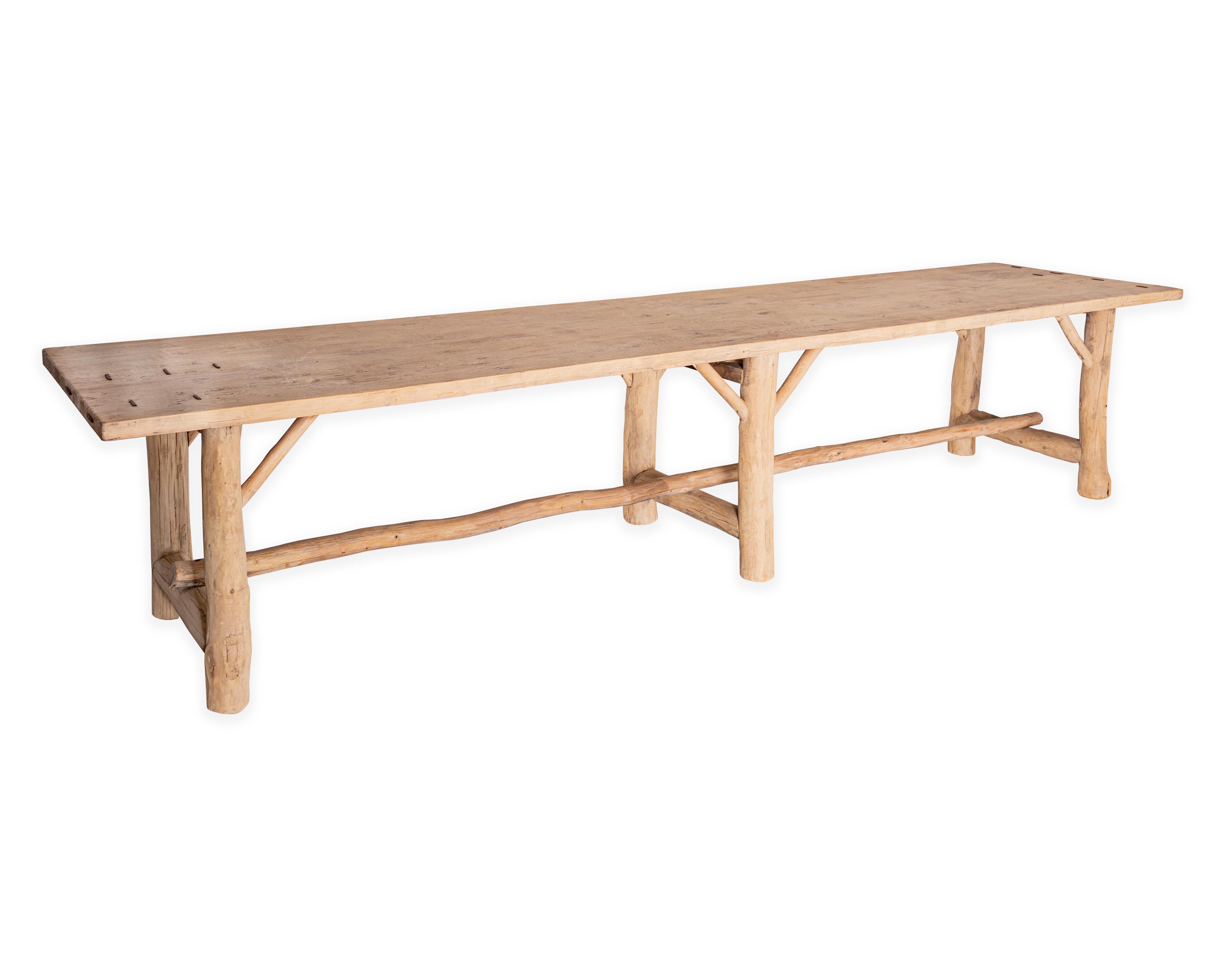Limb and trunk motif dining table, reclaimed elm with decorative metal accents. 

Piece from the Le Monde collection. Exclusive to Brendan Bass.
    