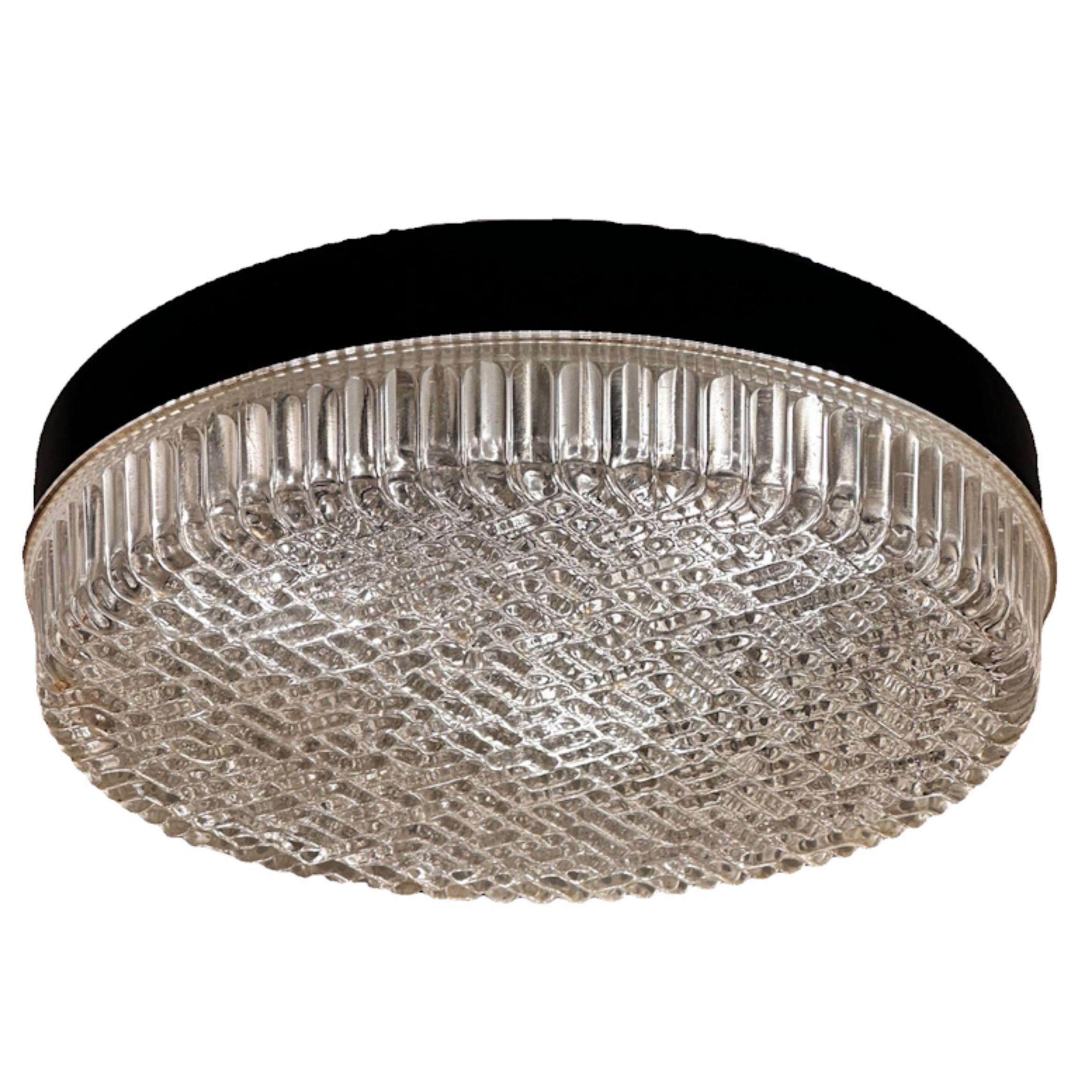 Attributed to Germany's top lighting manufacturer, Glasshutte Limburg and remeniscent of lighting designed by Helena Tynell, these flush mounts feature  a unique bubble glass lense consisting of small round and capsule shaped bubbles that create a