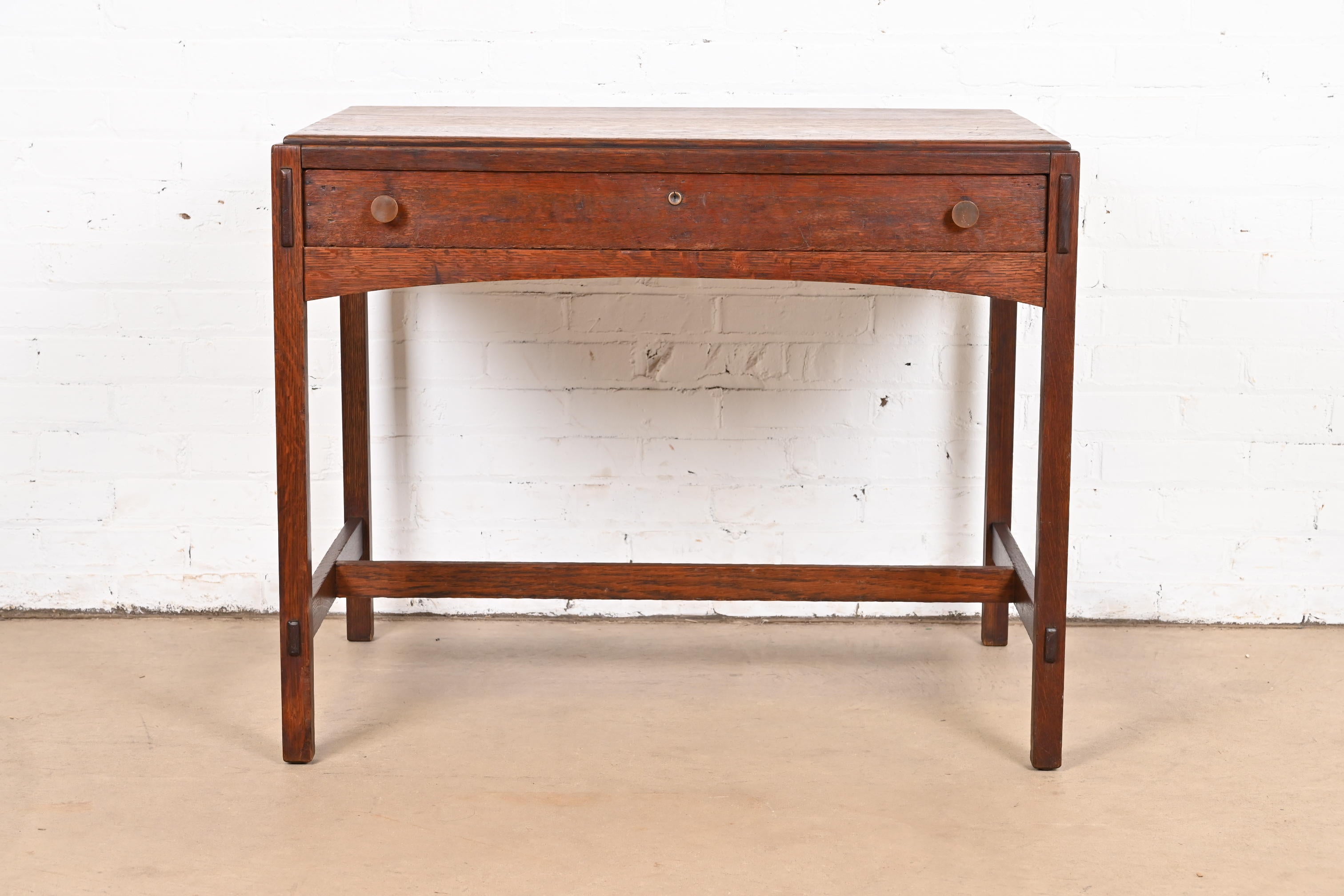 A gorgeous antique Mission or Arts & Crafts library table or writing desk

By Charles P. Limbert Co.

USA, Circa 1900

Quarter sawn oak, with original copper hardware.

Measures: 36