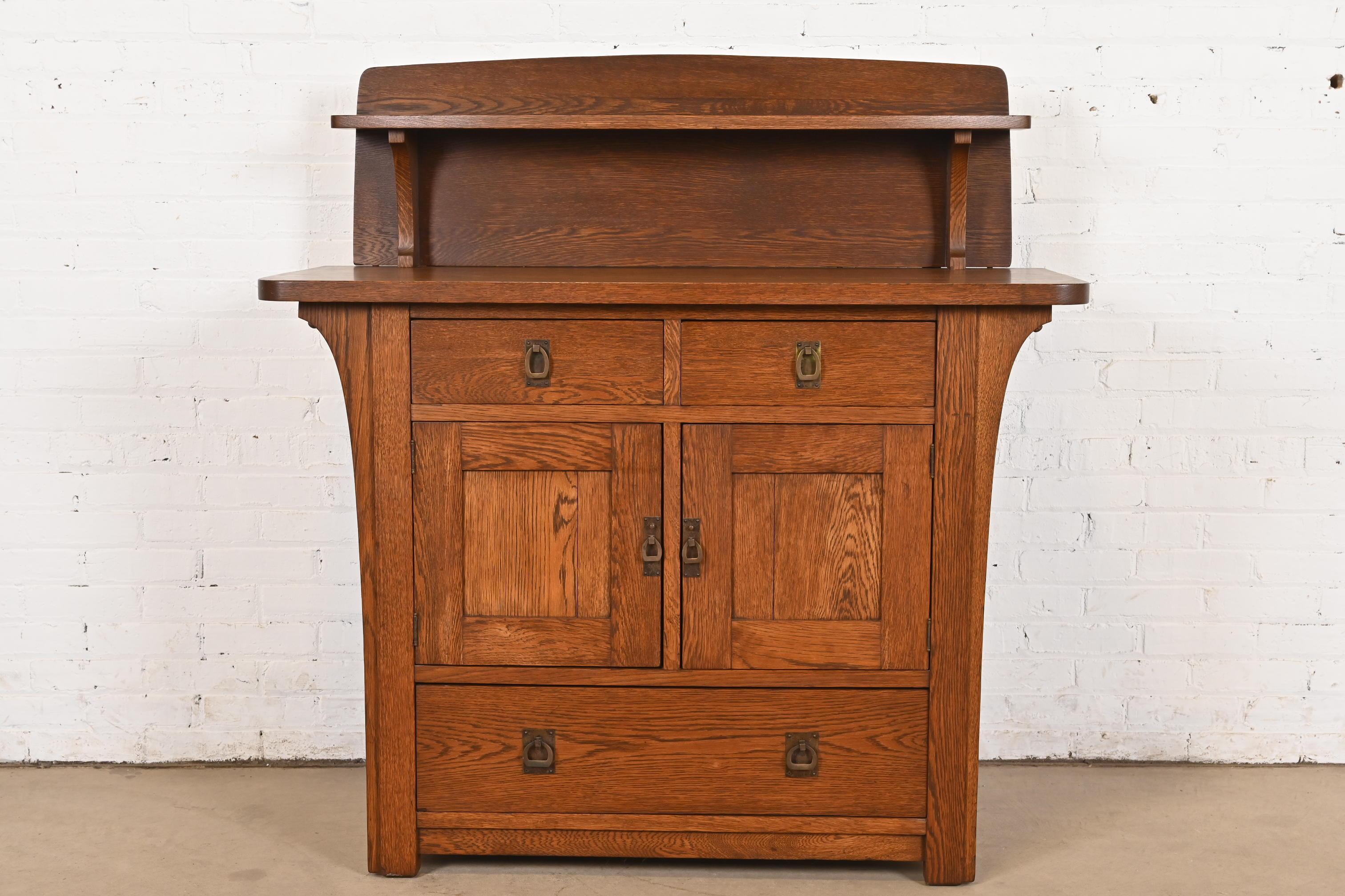 An exceptional antique Mission or Arts & Crafts period sideboard, credenza, buffet server, or bar cabinet

By Charles P. Limbert Co.

USA, Circa 1900

Quartersawn oak, with original hammered copper hardware.

Measures: 48