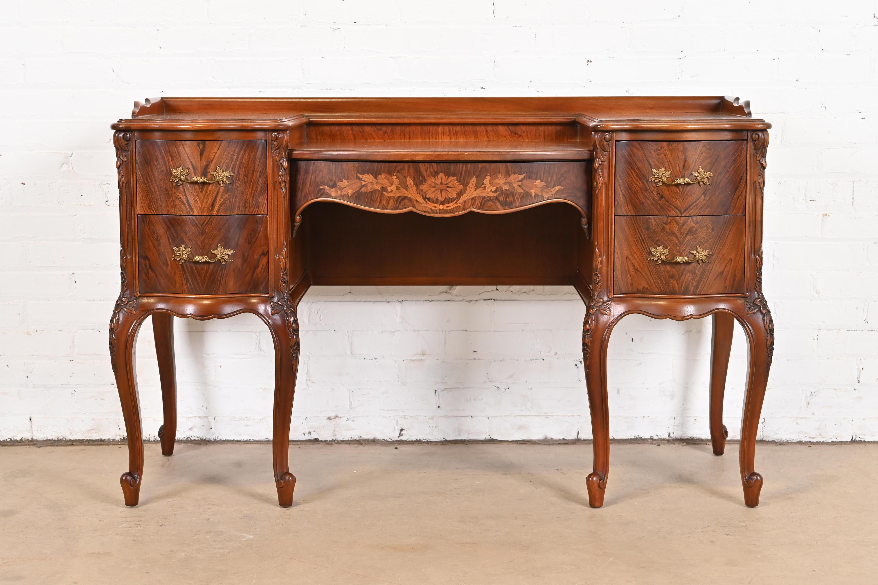 A gorgeous French Provincial Louis XV style vanity

By Limbert

USA, 1920s

Beautiful book-matched rosewood, with inlaid satinwood marquetry, and original brass hardware.

Measures: 50.75